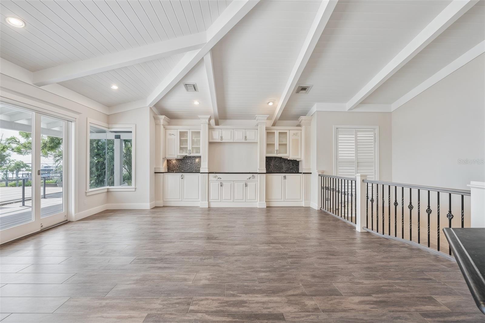 Open family room with vaulted ceilings, naturel light. and a seamless flow to the designer kitchen.