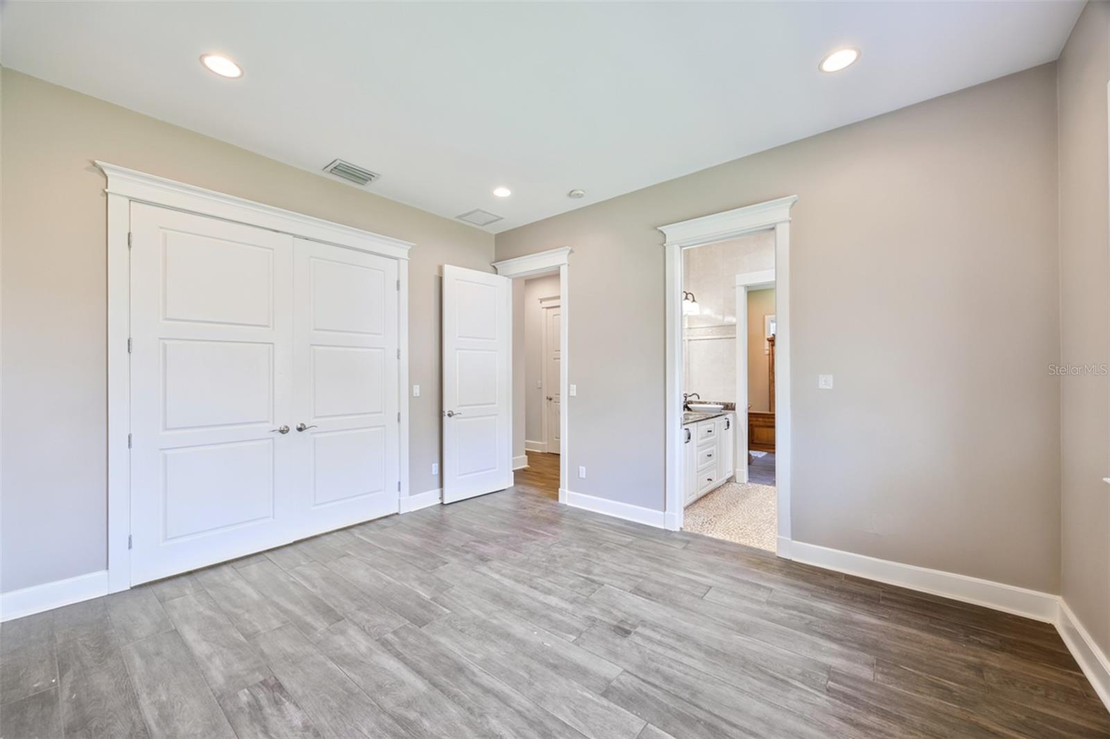 Bright guest bedroom offering easy access to the shared Jack-and-Jill bath.