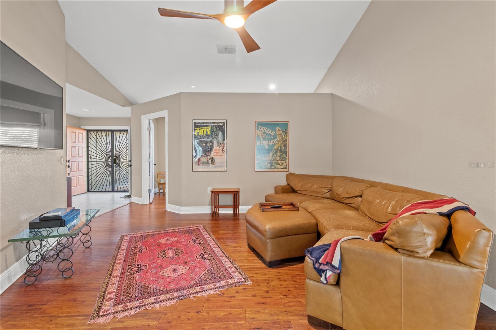 `Formal living room with soaring ceilings and hardwood floors.