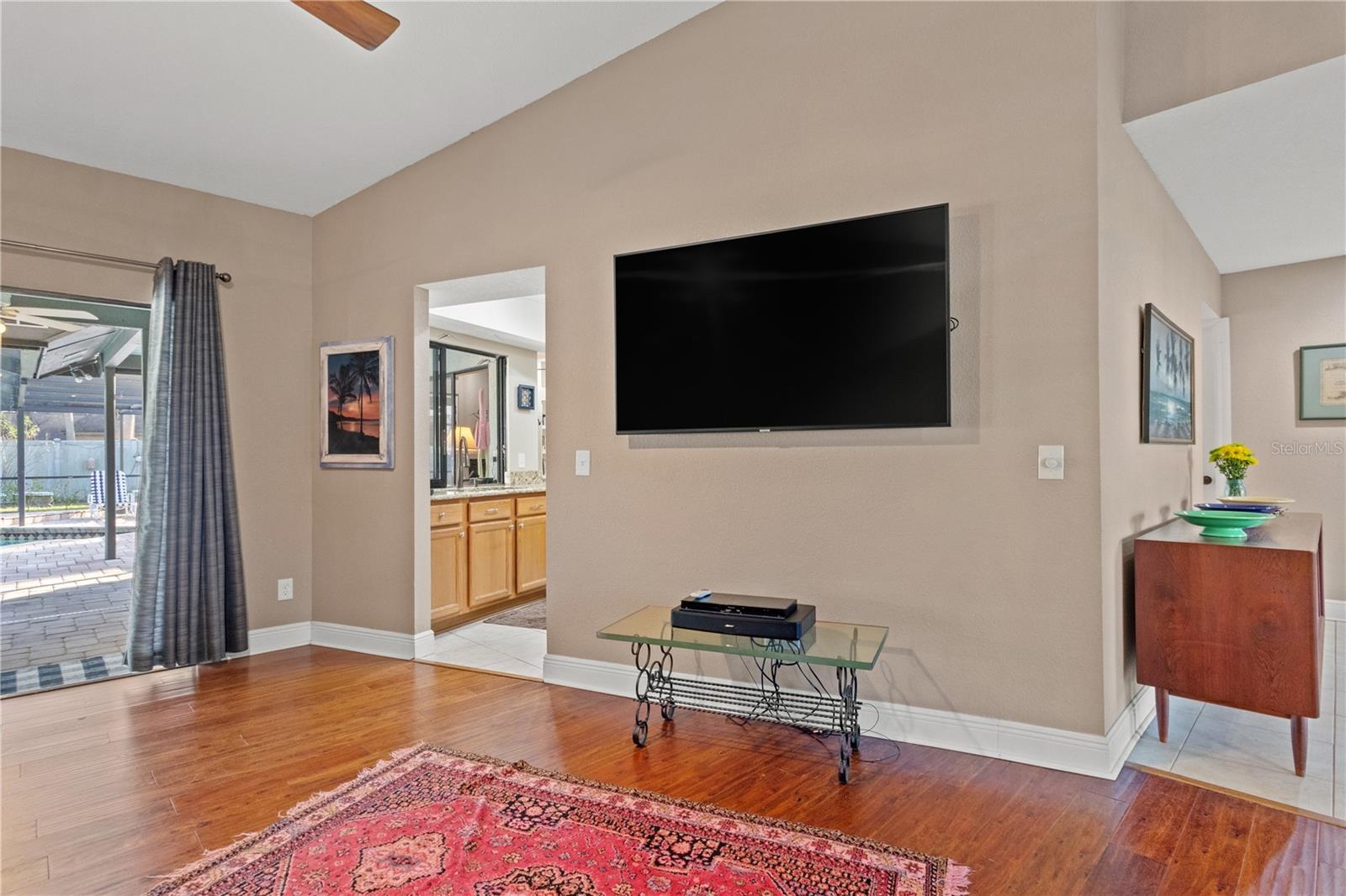 The living room flows seamlessly to the pool and the kitchen.