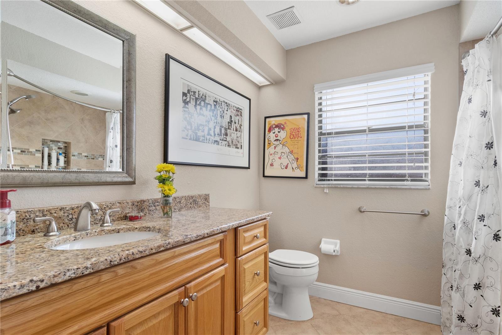 The secondary bathroom does not skimp on storage and vanity space
