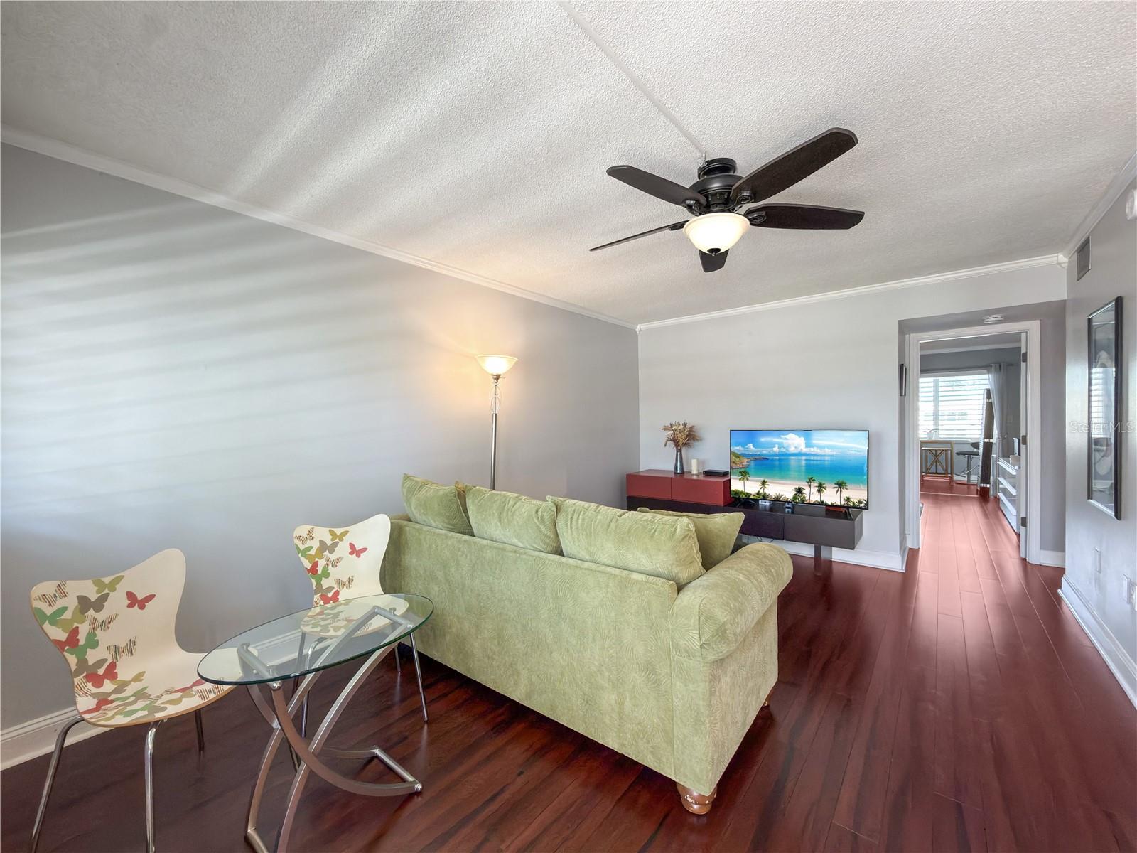 Living Room Features Designer Paint and Crown Moulding