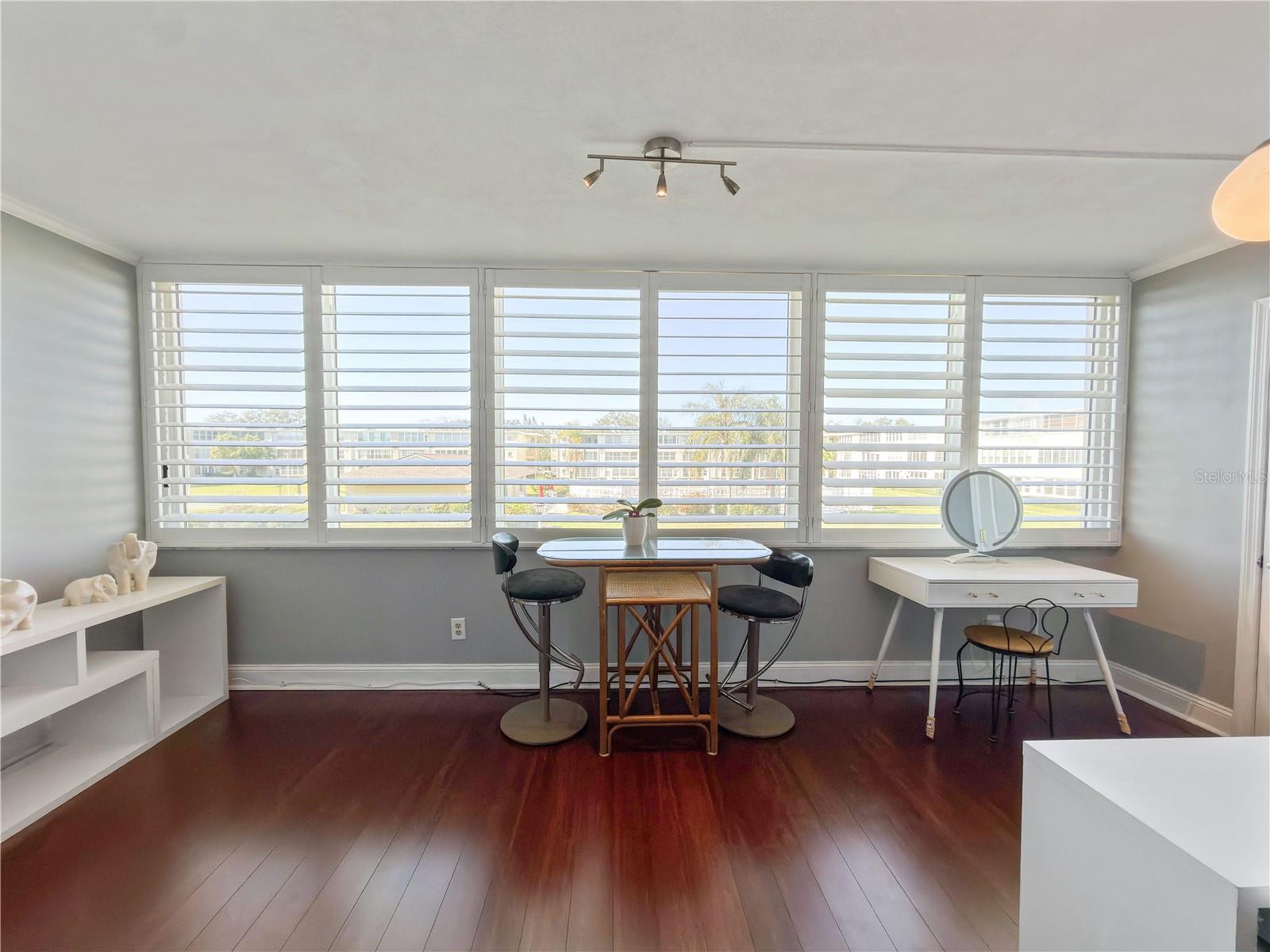Entire Wall of Triple Pane Windows with More Plantation Shutters