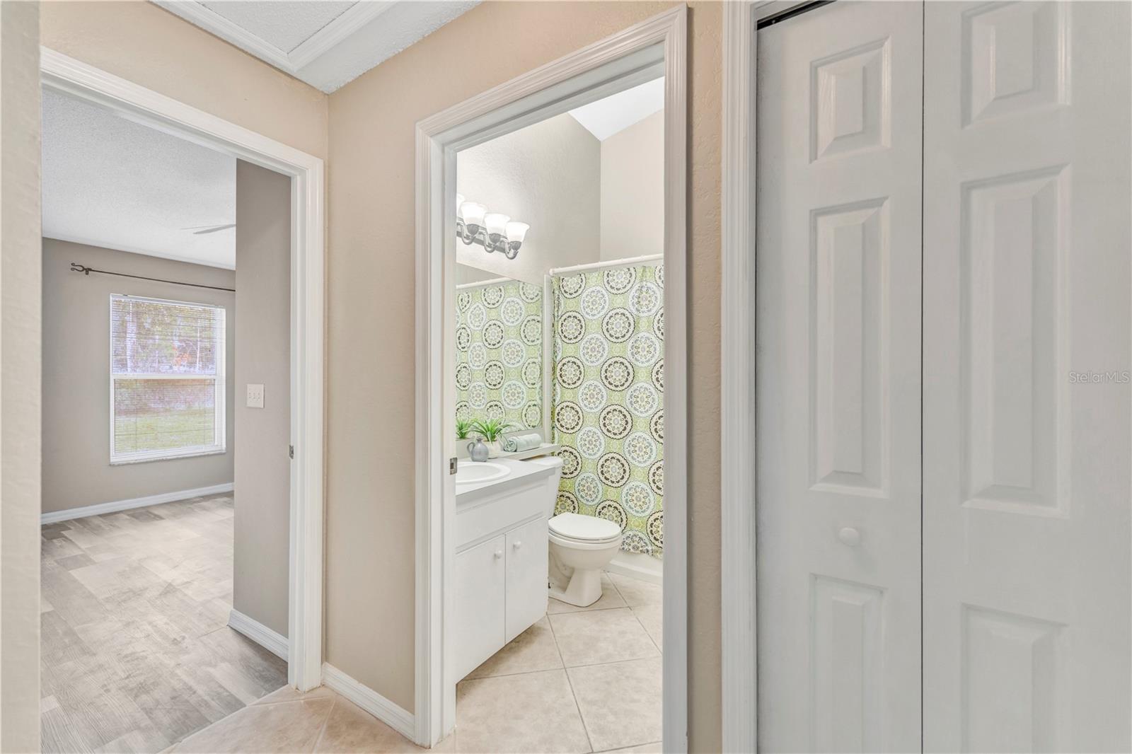 Hallway w/ full bathroom between two bedrooms