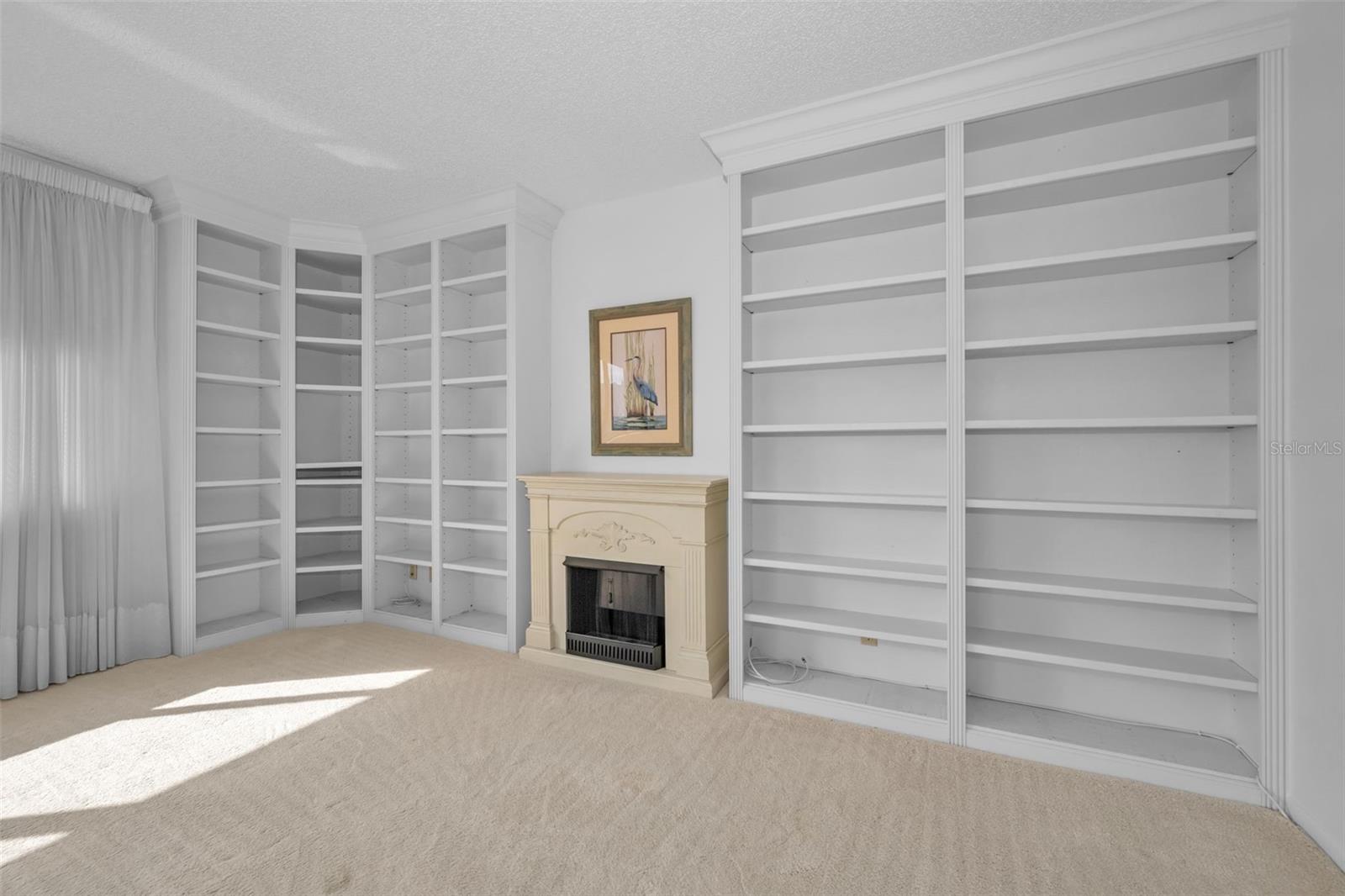 Family room bookcases and faux fireplace.