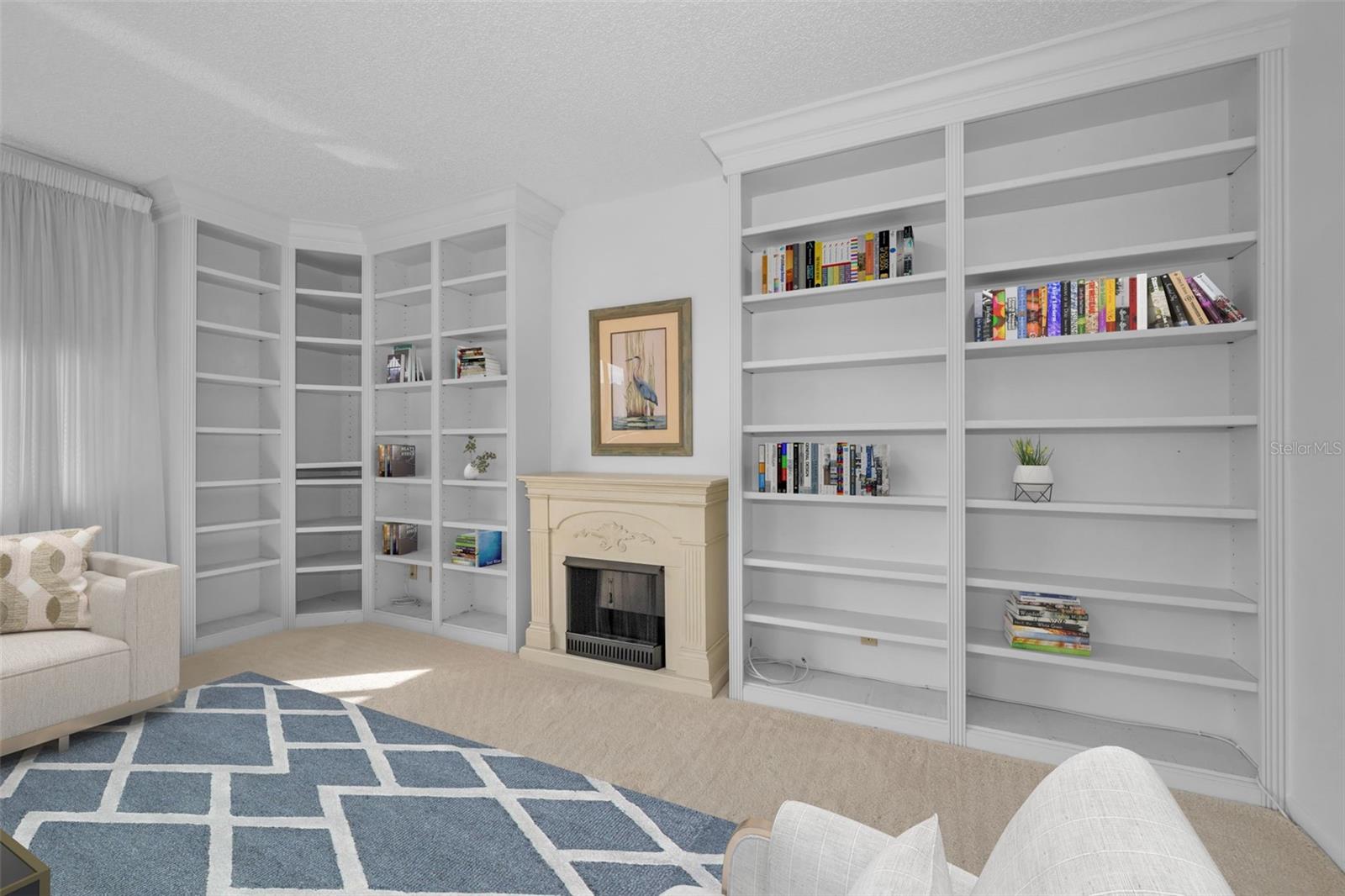 Family room, bookcases and faux fireplace.