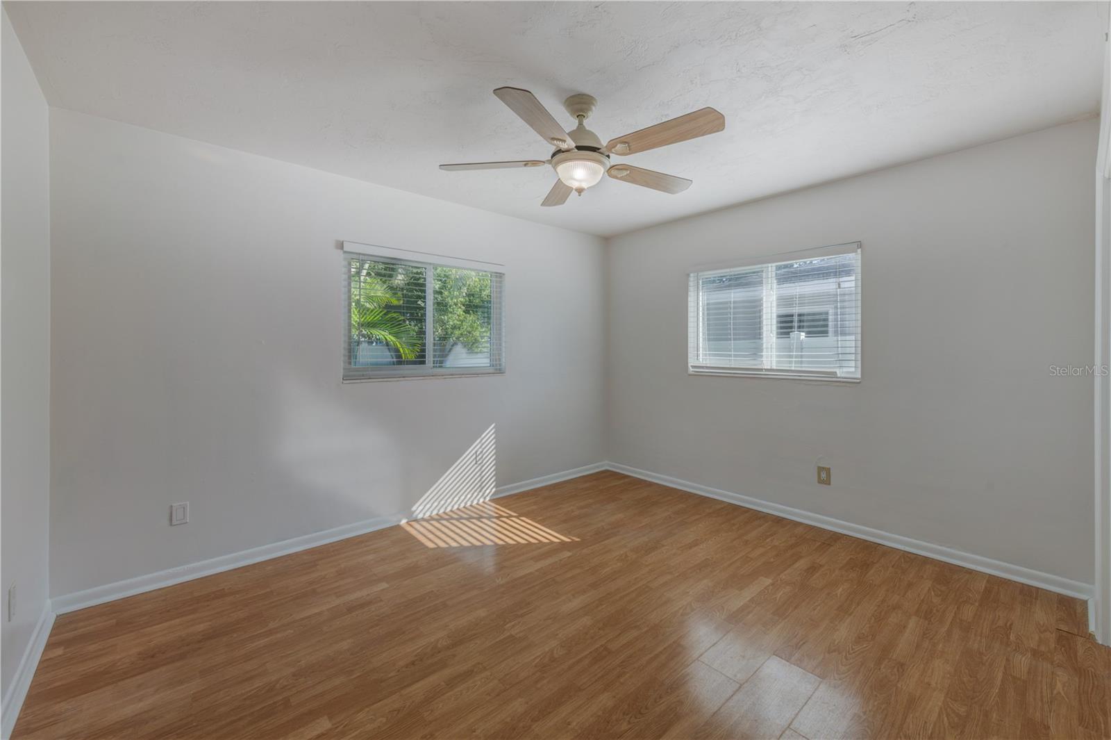 BACK BEDROOM WITH DOOR LEADING TO THE LANAI