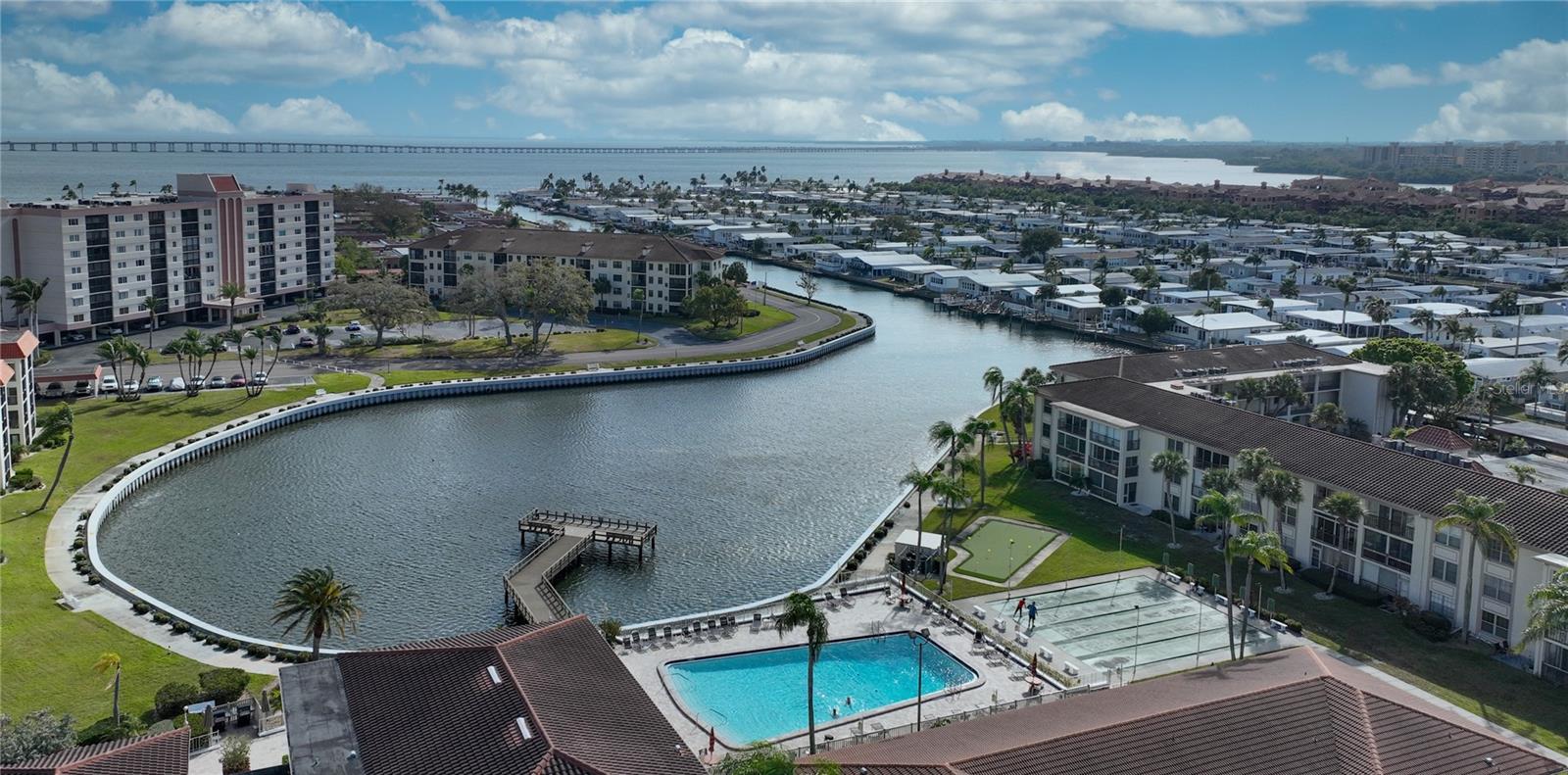 Aerial of the cove, fishing pier, pool, shuffleboard and putting green