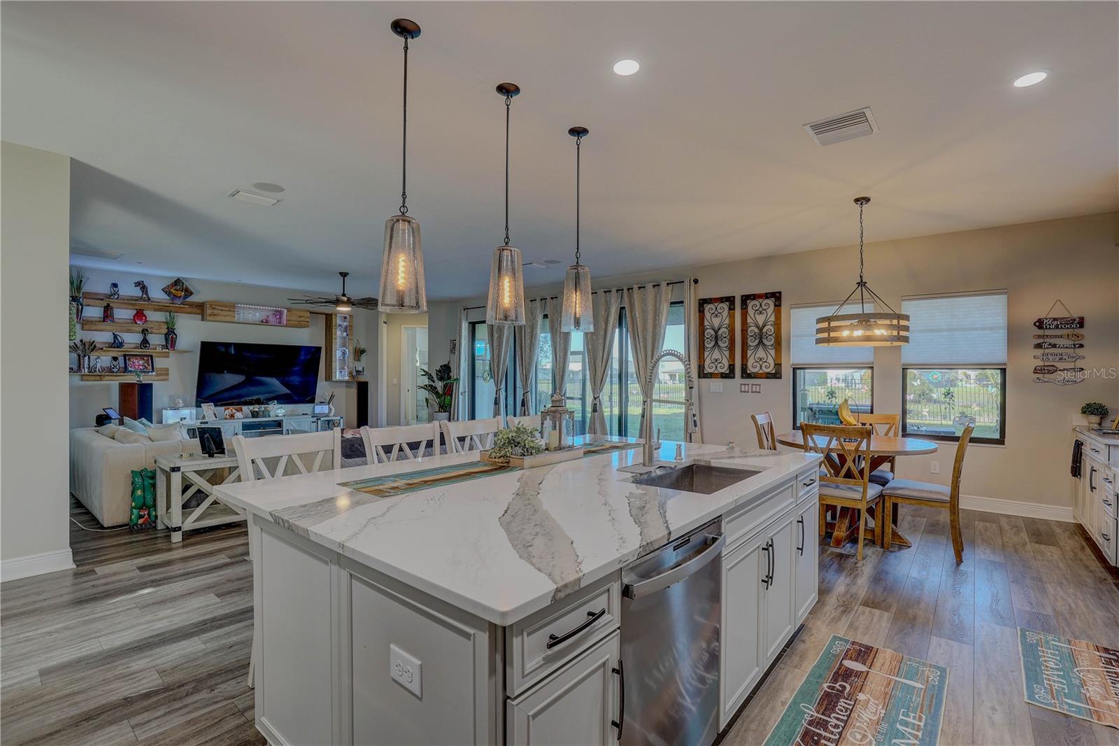 Massive custom quartz island with extra storage on both sides.