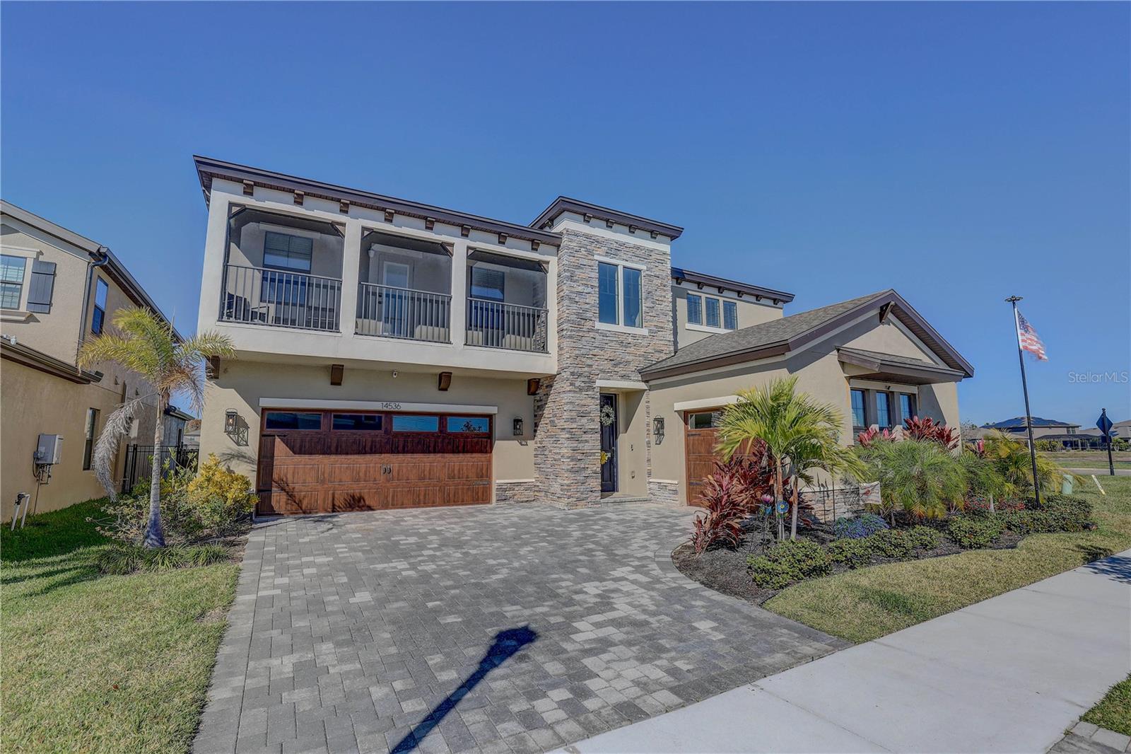 Split 3 car garage and paver driveway.