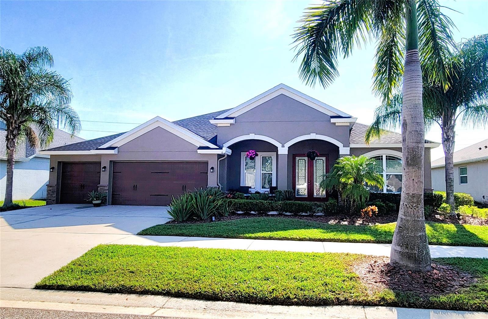 well-maintained façade, arched architectural details, and a spacious 3-car garage.