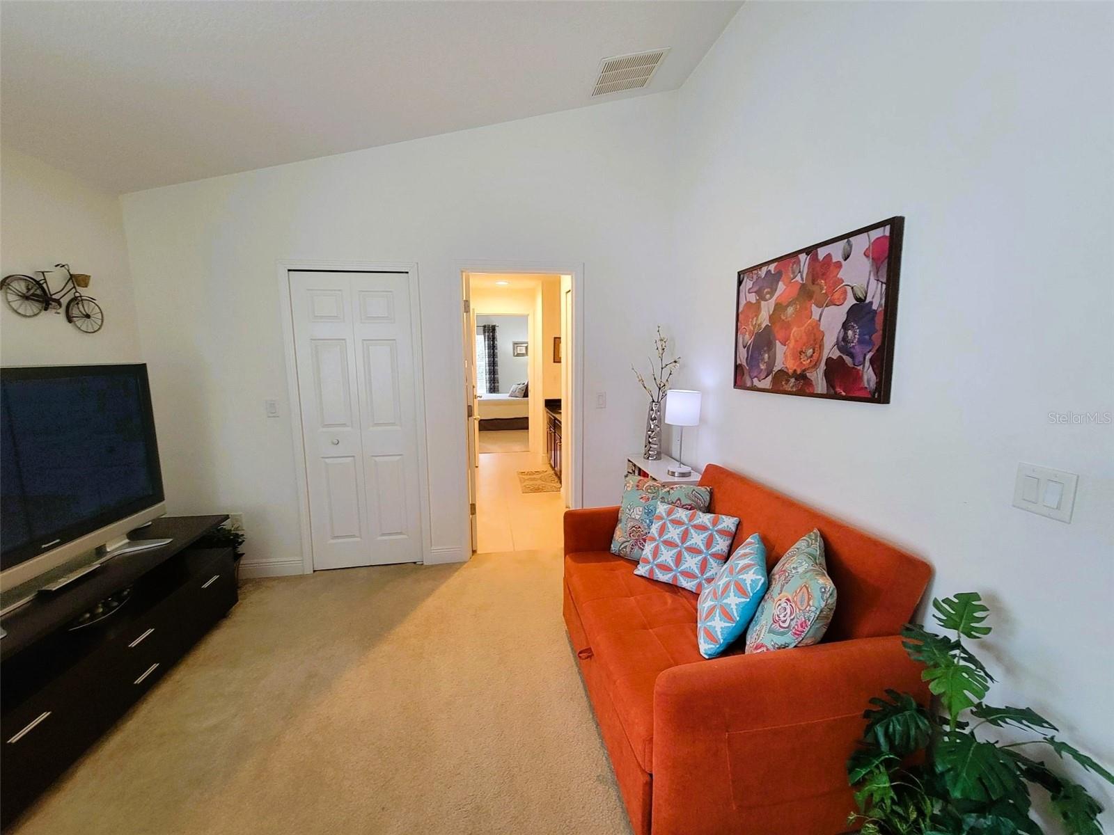 Spacious secondary bedroom with plush carpet, ample natural light, and flexible layout for bedroom, office, or guest space.