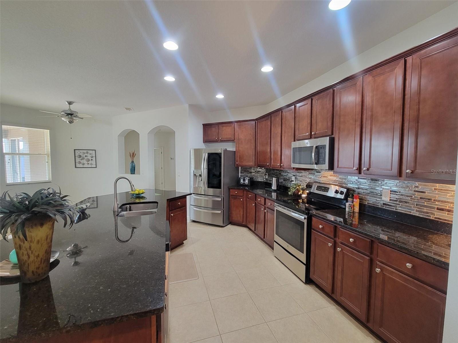 Well-appointed kitchen with rich cabinetry, stainless steel appliances, and ample counter and storage space.