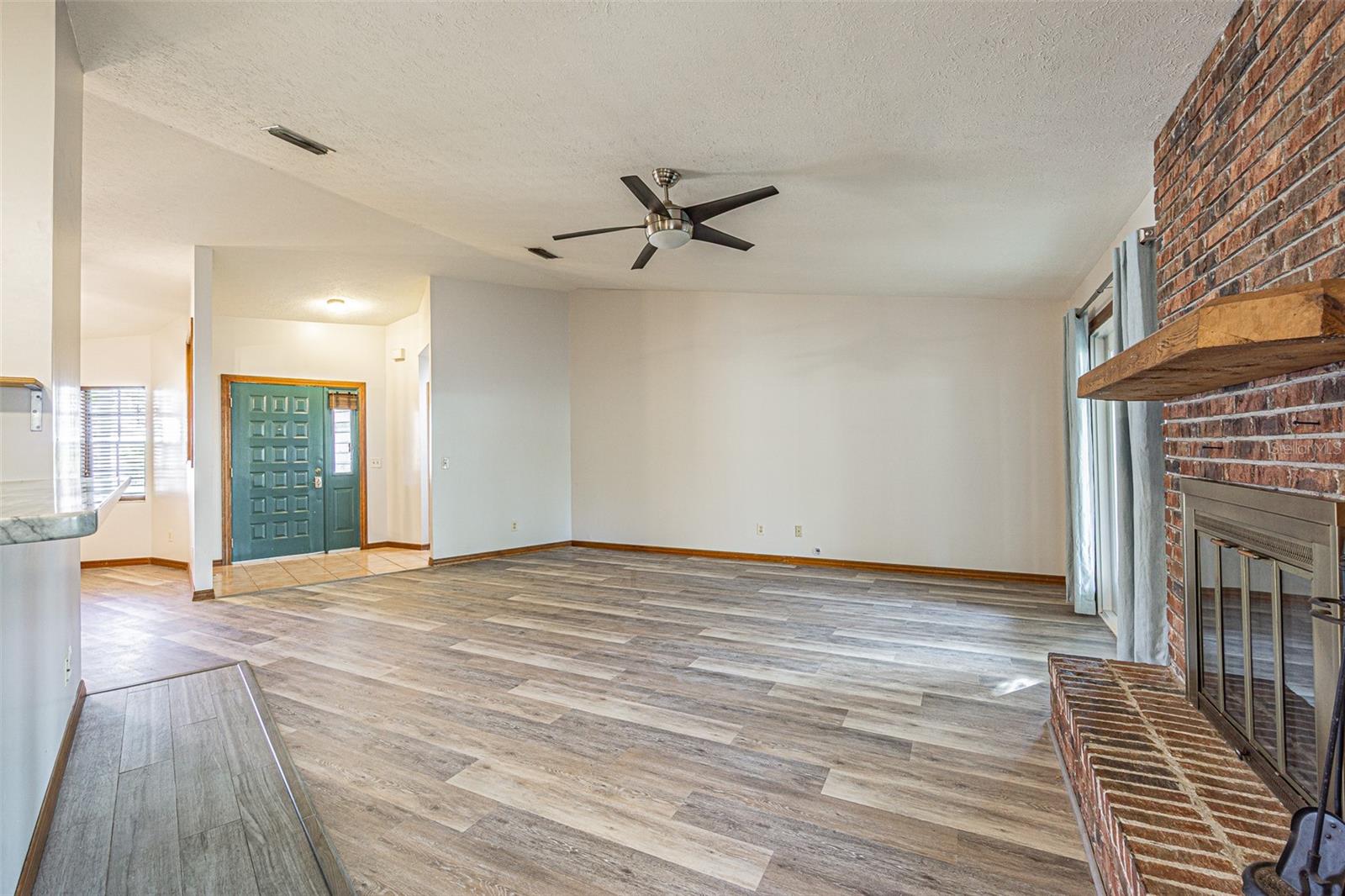 Huge living room, looking from eat-in kitchen area thru to front door