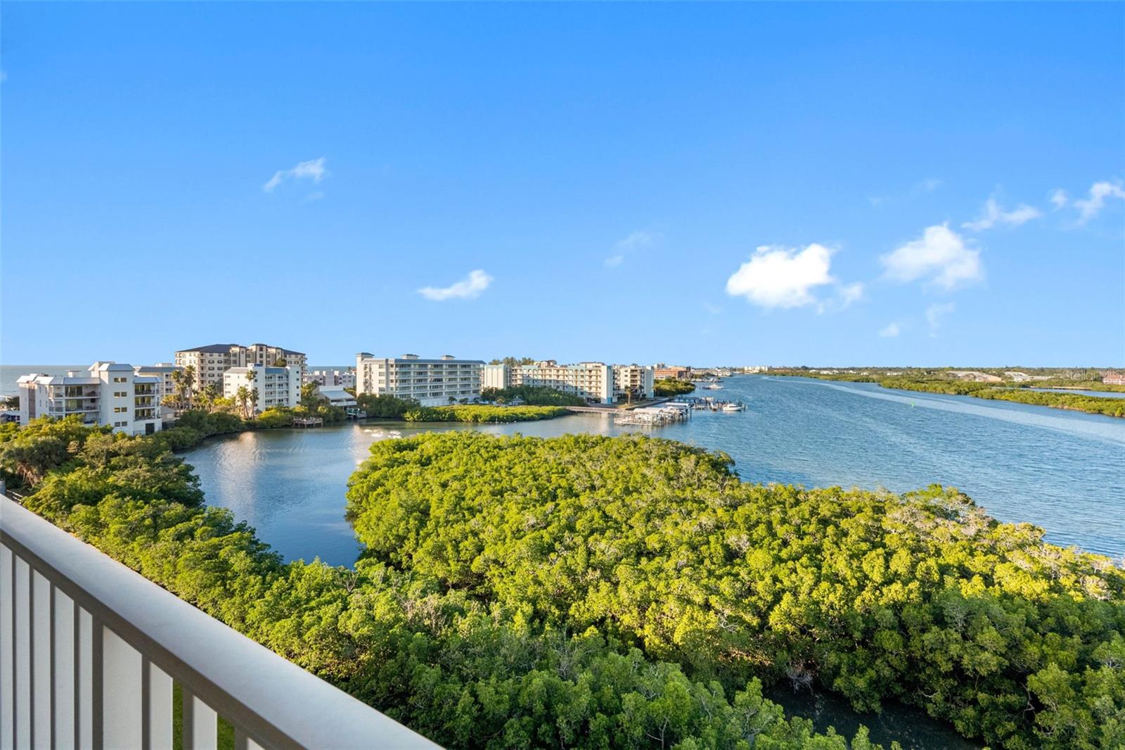 ... 7th Floor Affords Sunset Views To Left and Long Range water Views.. The Little Protected Inlet of Water to Left in Photo is where the Mama Dolphins Like To Teach Their Young to Fish. The Aunts Will Trap Fish in Here and Let the Young Calves Learn to Catch & Eat. Photo Taken on Balcony of Unit # 706.