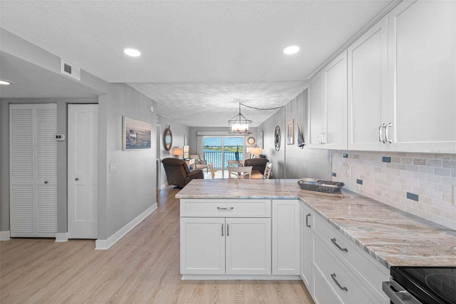 ...Kitchen Photo # 4. Mechanical Closet on Left with Newer A/C and Water Heater. Open Floorplan Gives a More Modern Look.
