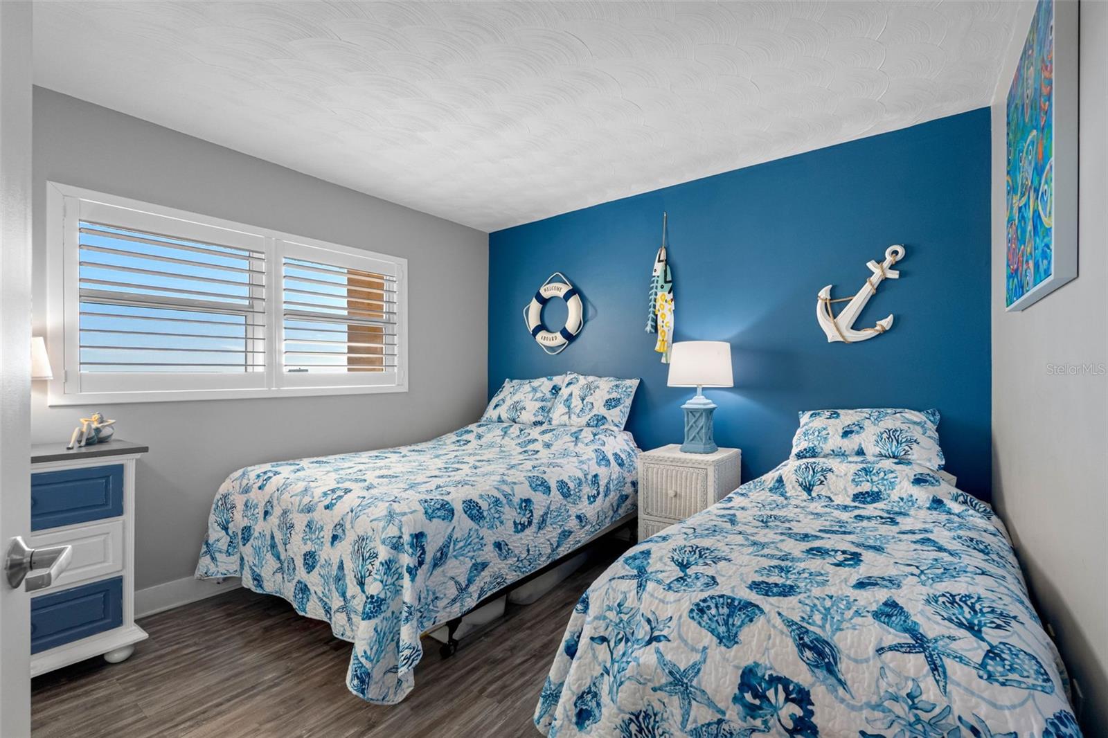 ... Guest Bedroom #1.. New Flooring - New Windows with Hurricane Glass - Plantation Shutters - New Wall Finish. Room is Large enough to Handle Two Singles or a Large Bed.