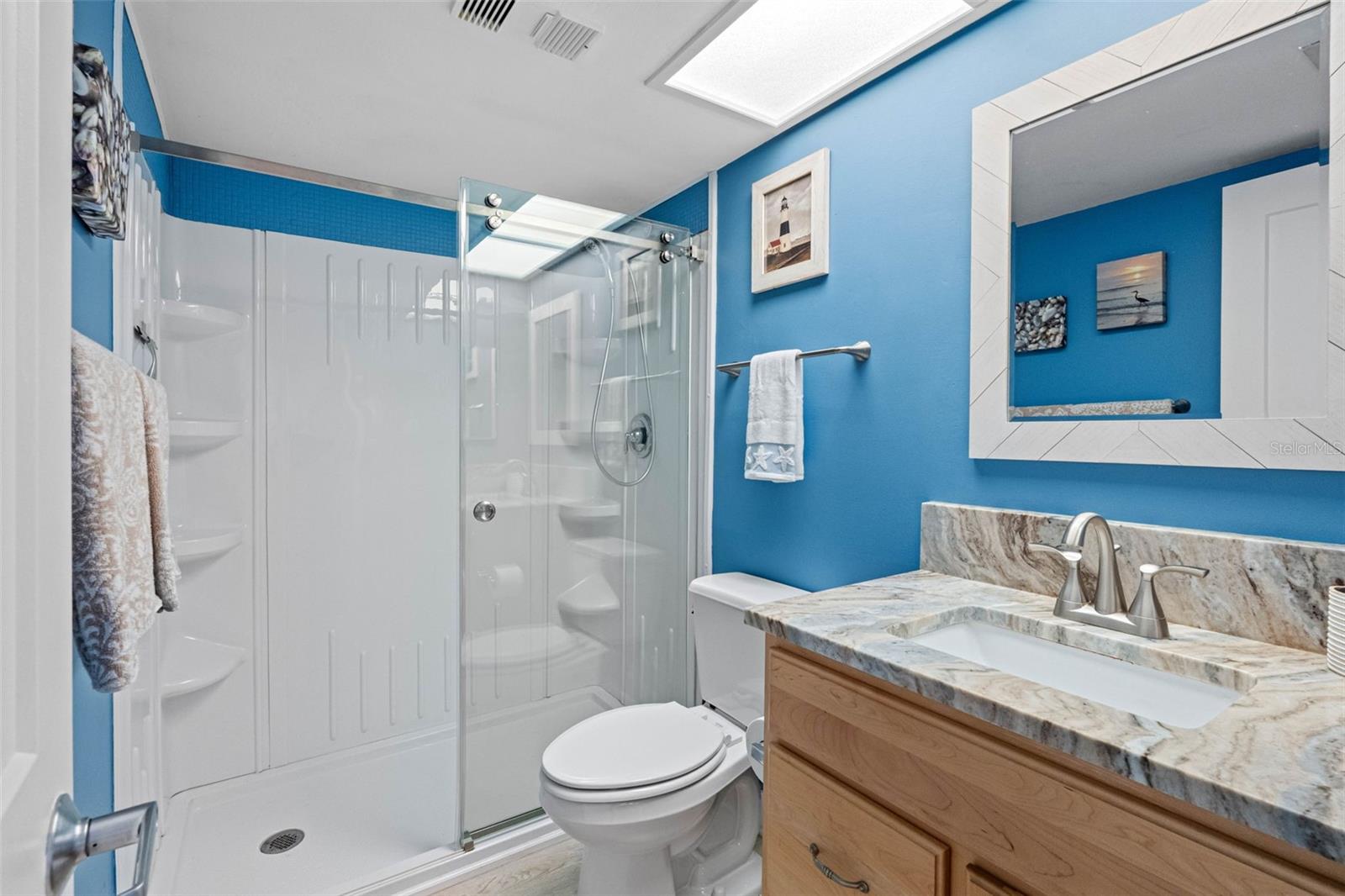 ... New Remodeled Bathroom Next to Guest Bedroom. This 2nd Bath Also Services Common Area.  Remodeled With Walk In Shower..  - New Shower - New Toilet - New Vanity, New Flooring and New Door.