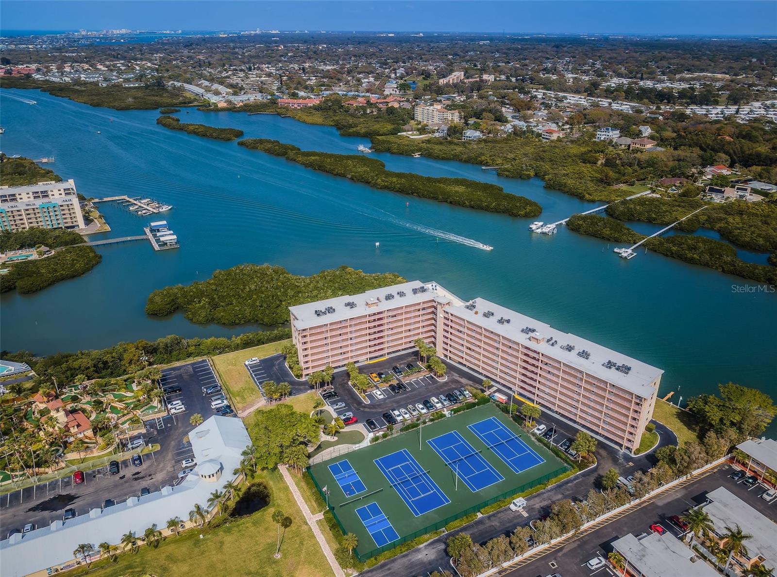 .. Aerial of Bay Shore Yacht & Tennis Club. Tennis & Pickle Courts Just Redone. Miniature Golf Course To Left of Complex. Beach is Right Across the Street. Shot Looking North..
