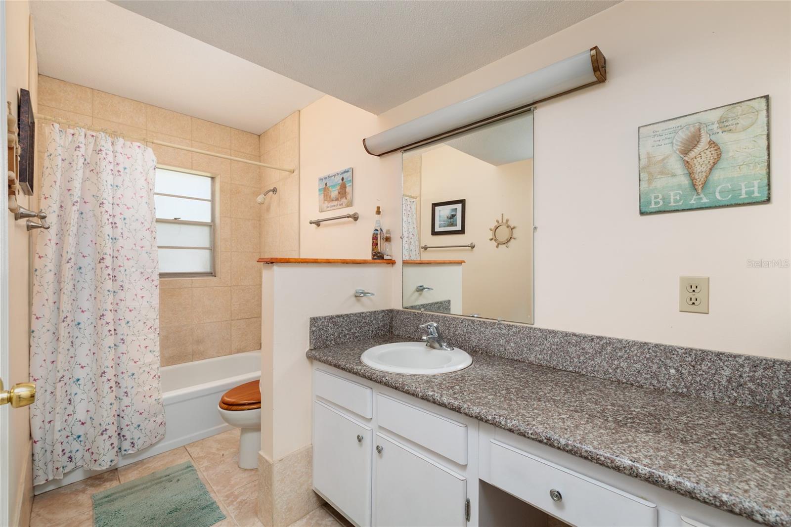 Bathroom w/Granite counter, make up vanity & linen closet.