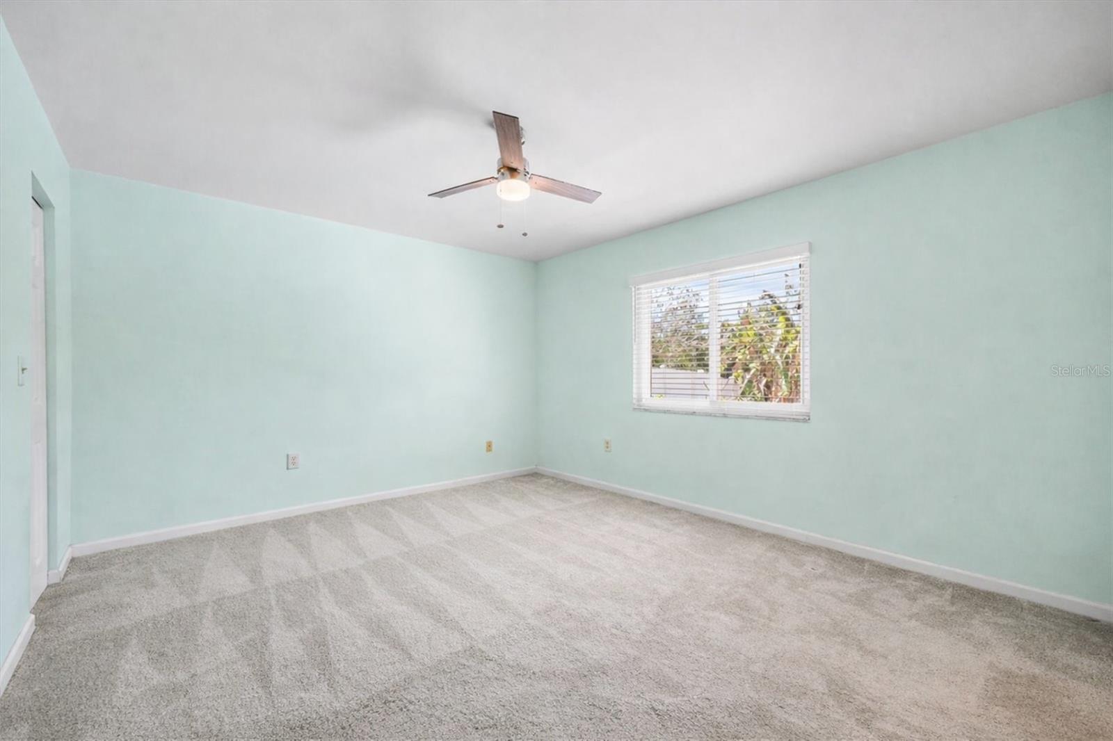 Primary Bedroom Suite overlooks backyard