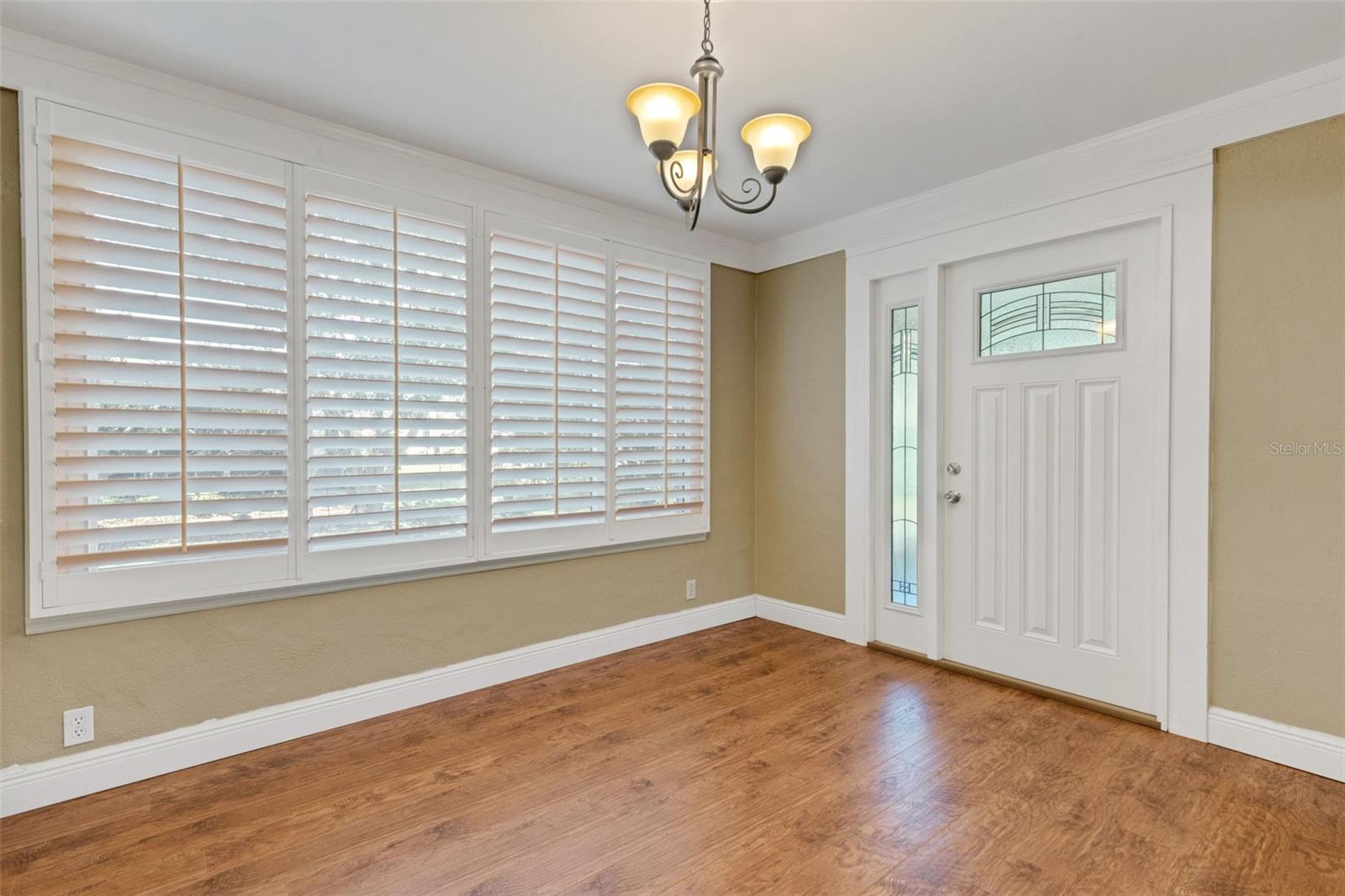 Beautiful shutters, lead glass door leads to enclosed Florida Room