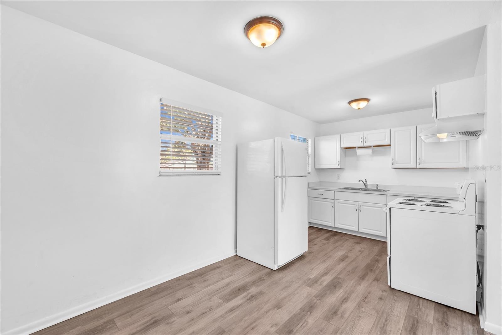 Durable vinyl flooring and fresh paint give a clean fresh look to this kitchen.