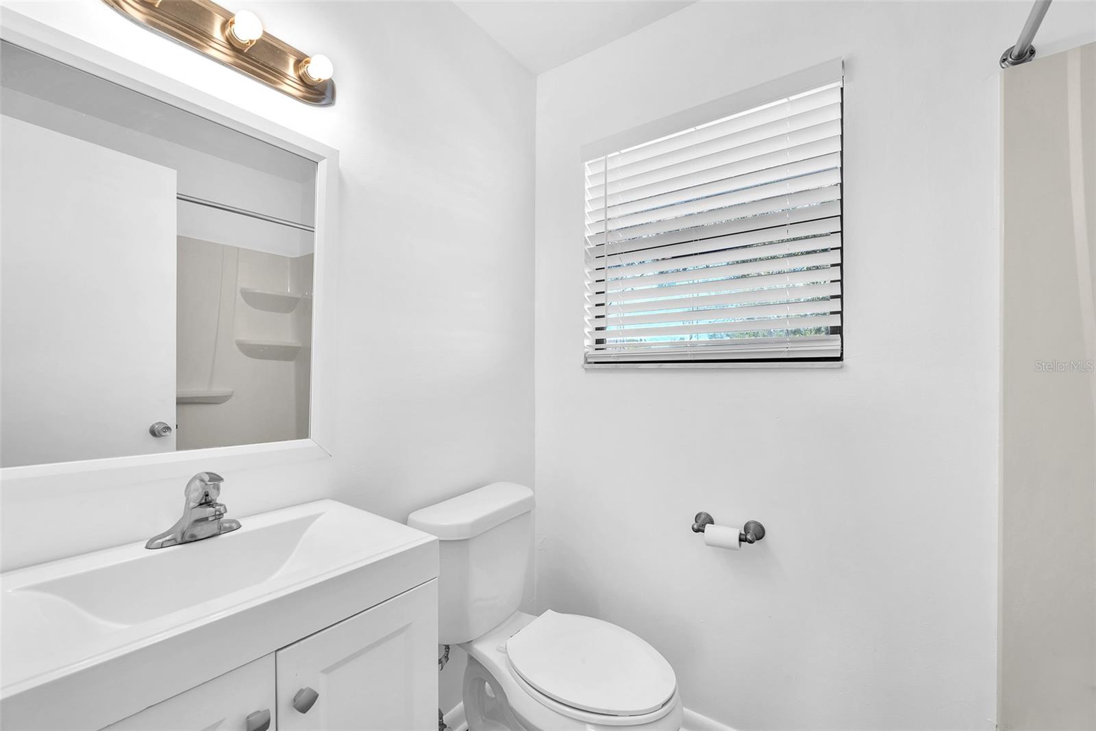 Freshly painted and floored bathroom with tub/shower combination.