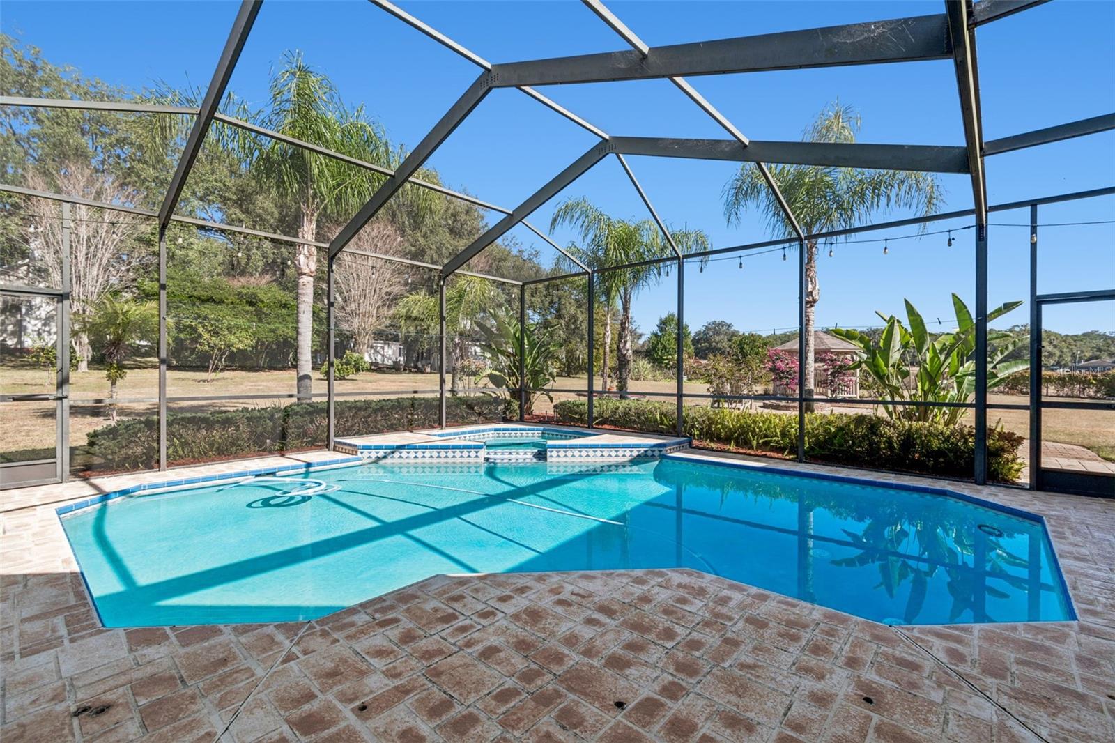 Private tropical oasis with mature landscaping and no rear neighbors.