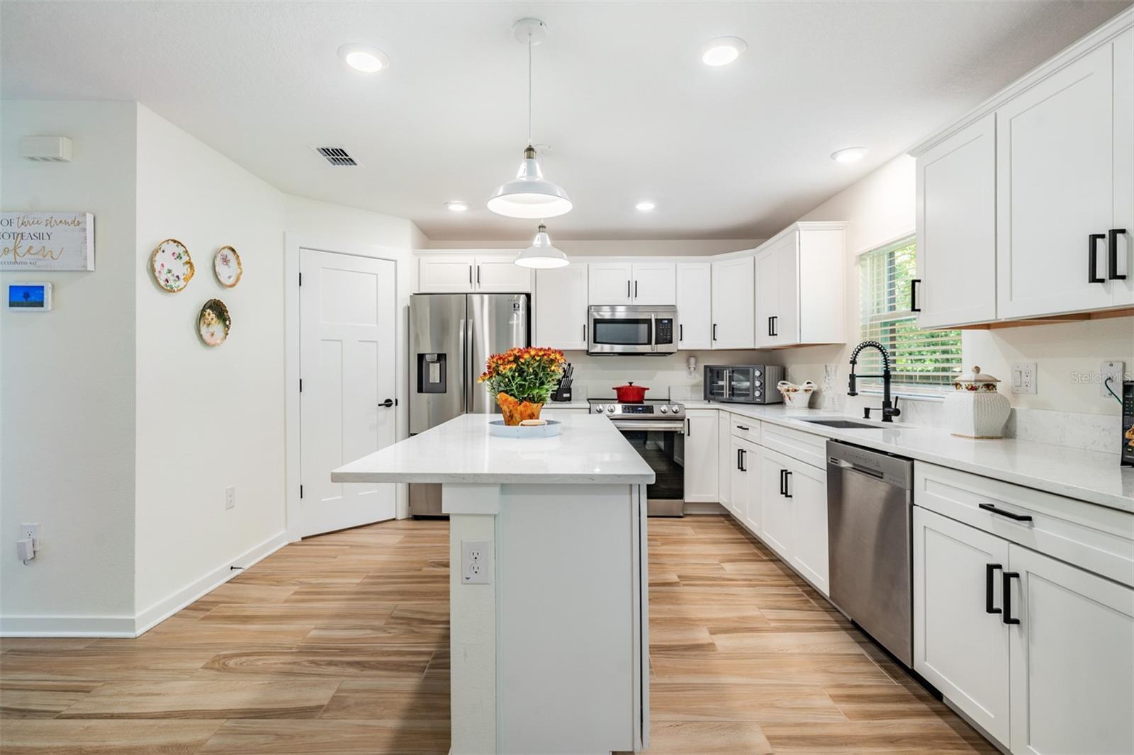 Gleaming kitchen with center island adding more storage
