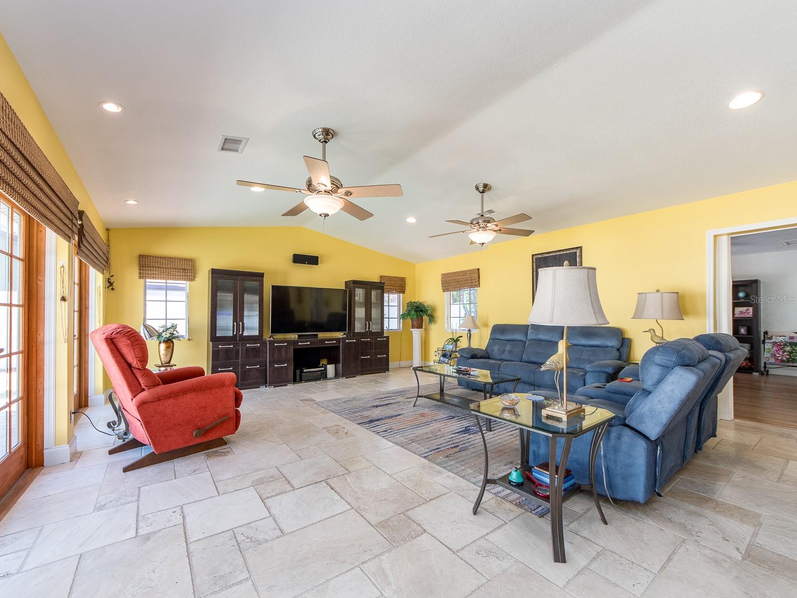 Spacious living area with access to the backyard and pool