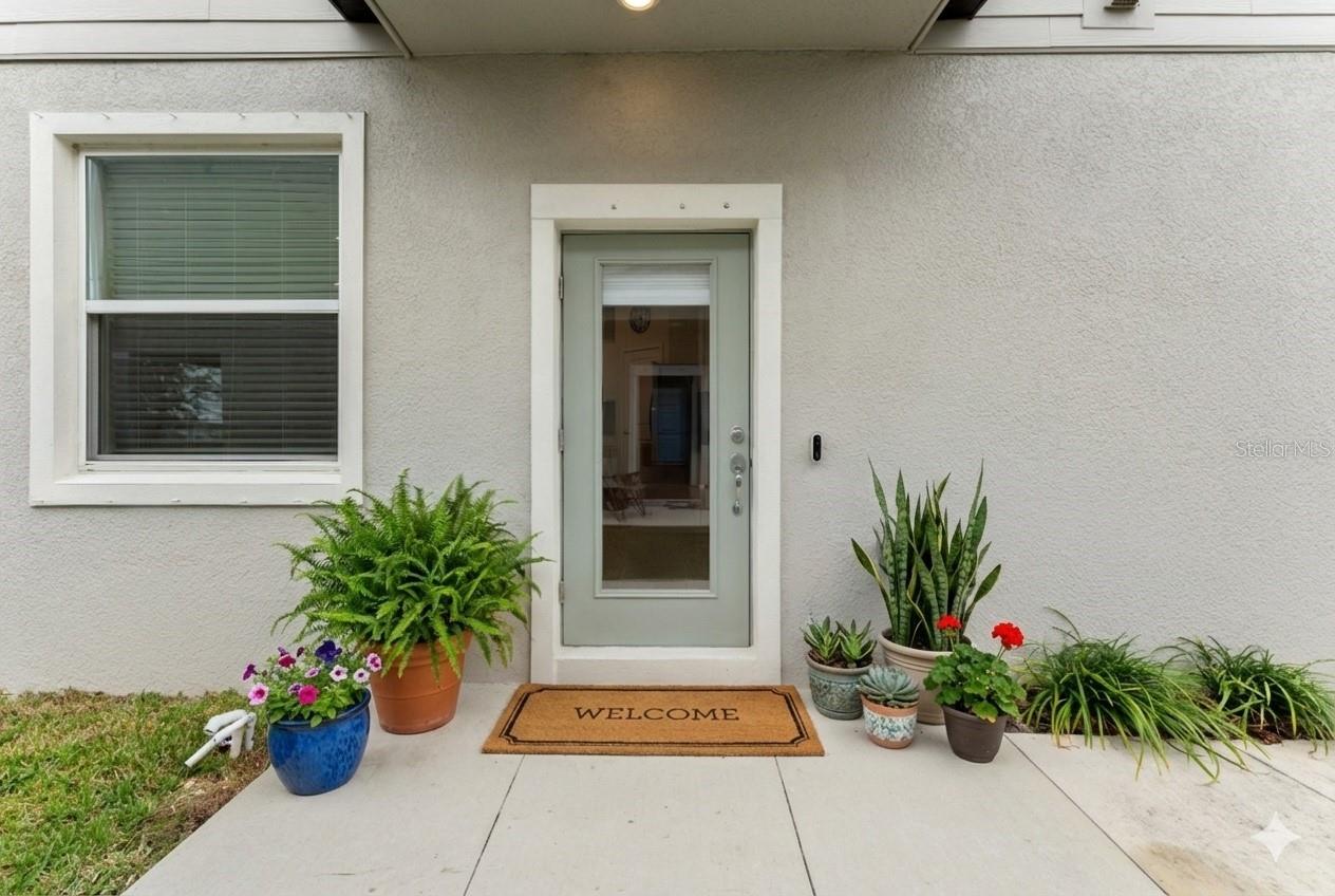 Freshly maintained façade with neutral tones, low-maintenance landscaping, and a private driveway leading to the attached two-car garage.