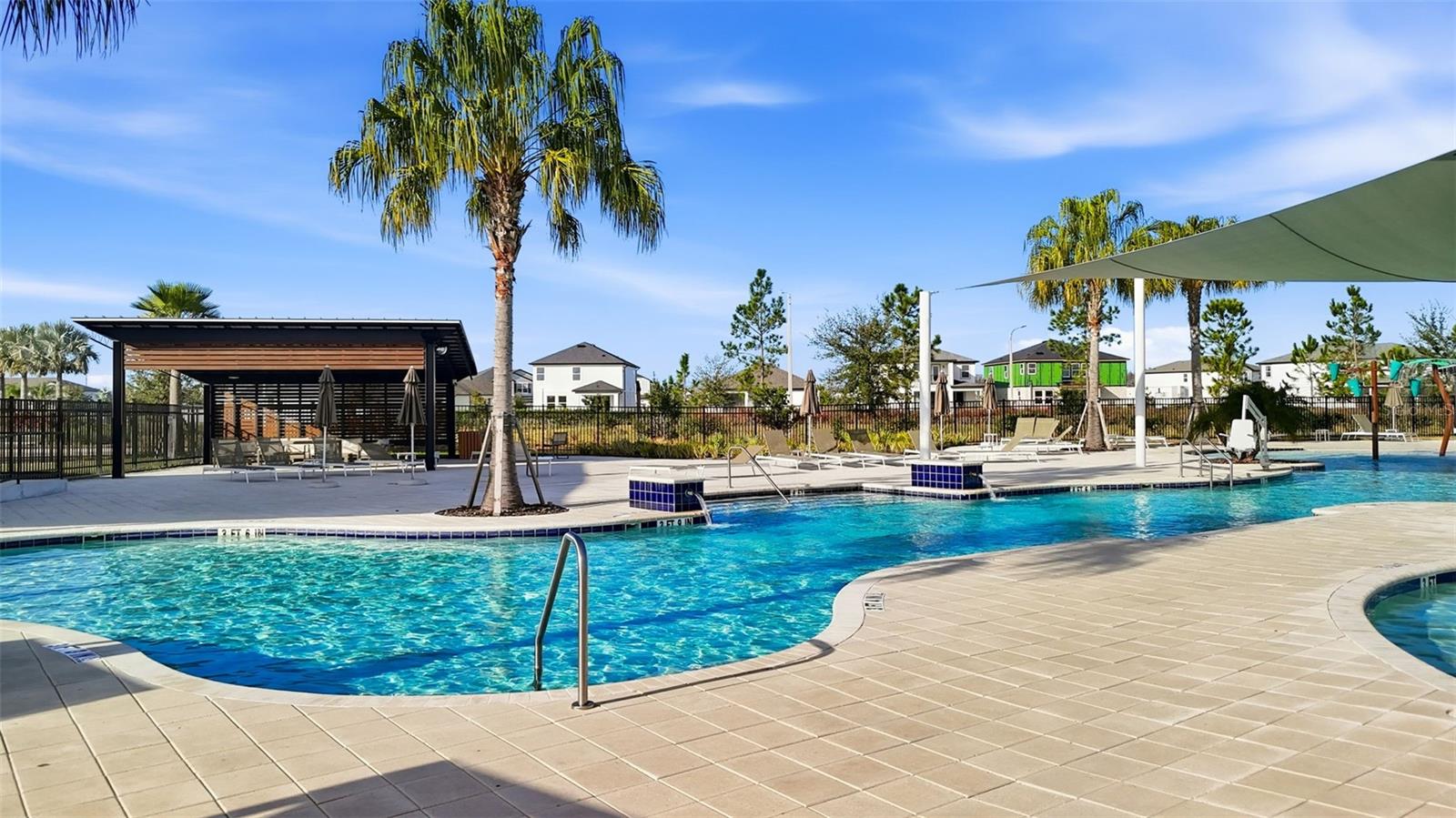 Open pool deck with modern loungers and umbrellas, providing plenty of space to unwind.