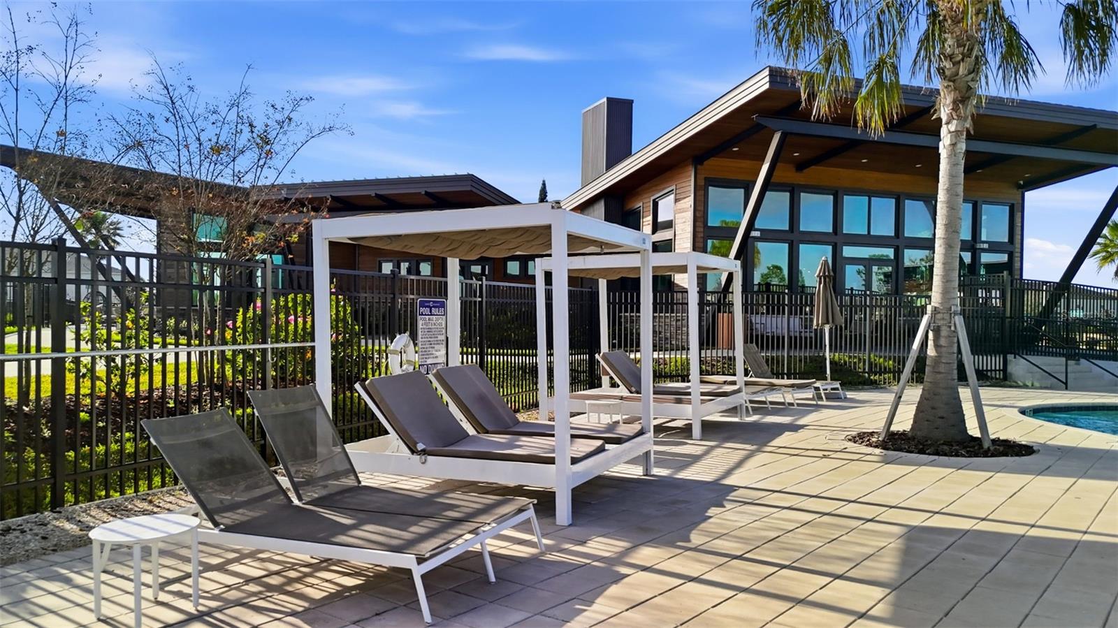 Stylish cabanas with loungers offer shaded relaxation steps from the water.