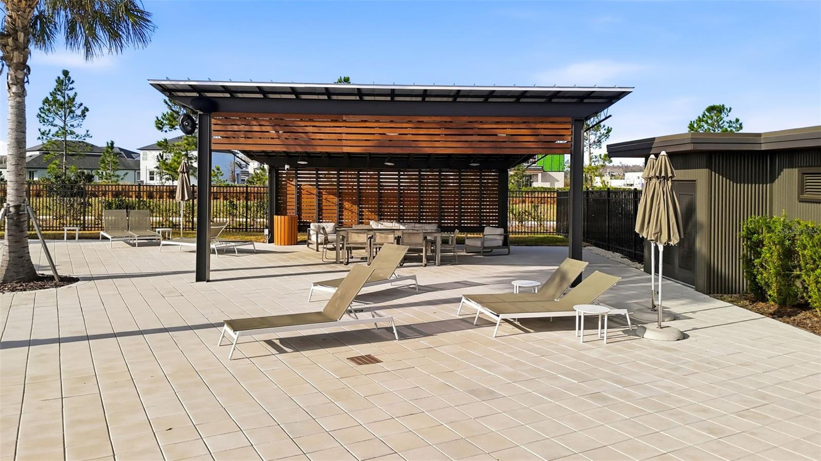 Contemporary pavilion with seating areas designed for casual outdoor dining and social gatherings.