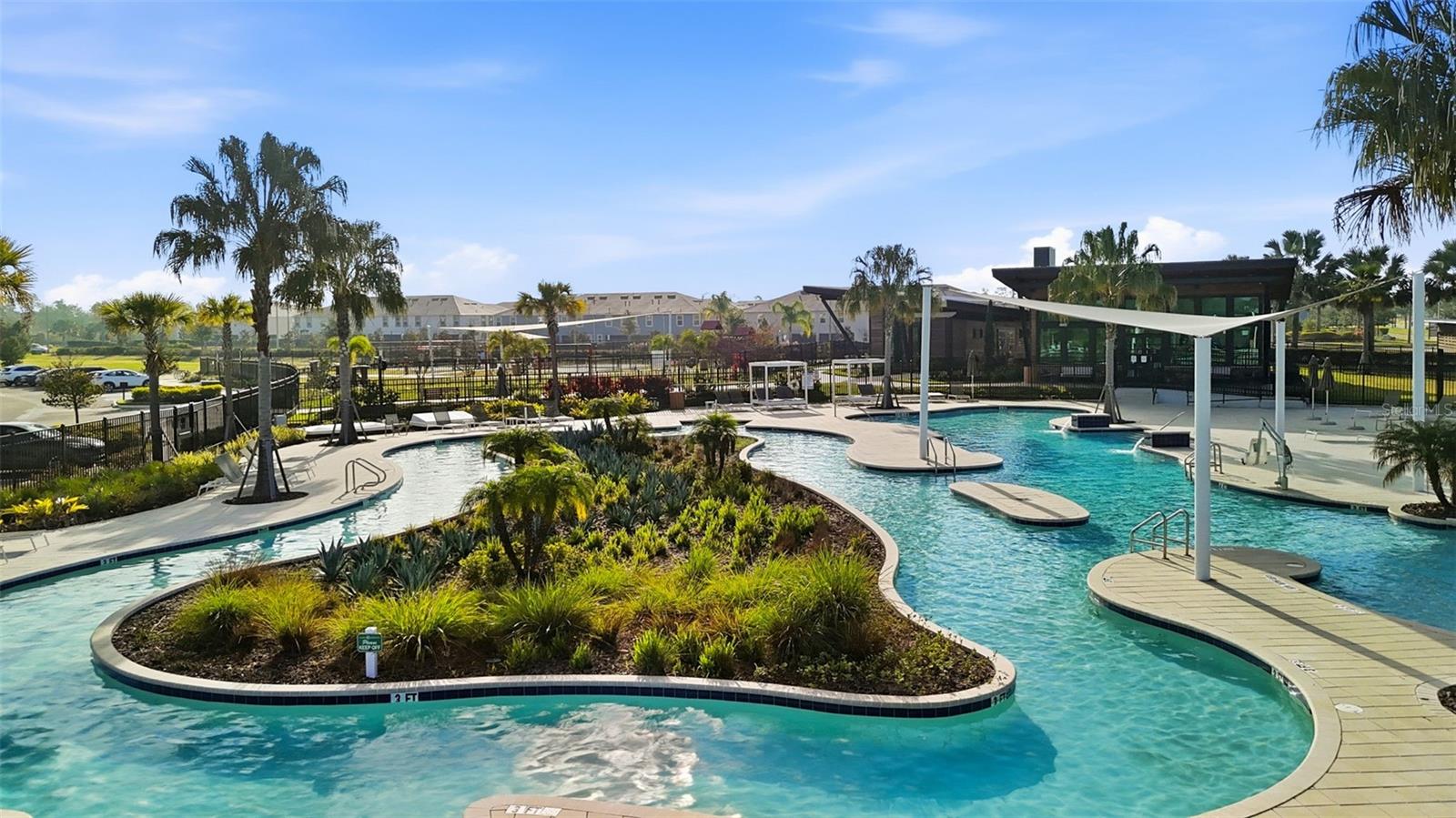 Beautifully designed pool with landscaped islands, curved walkways, and multiple entry points.