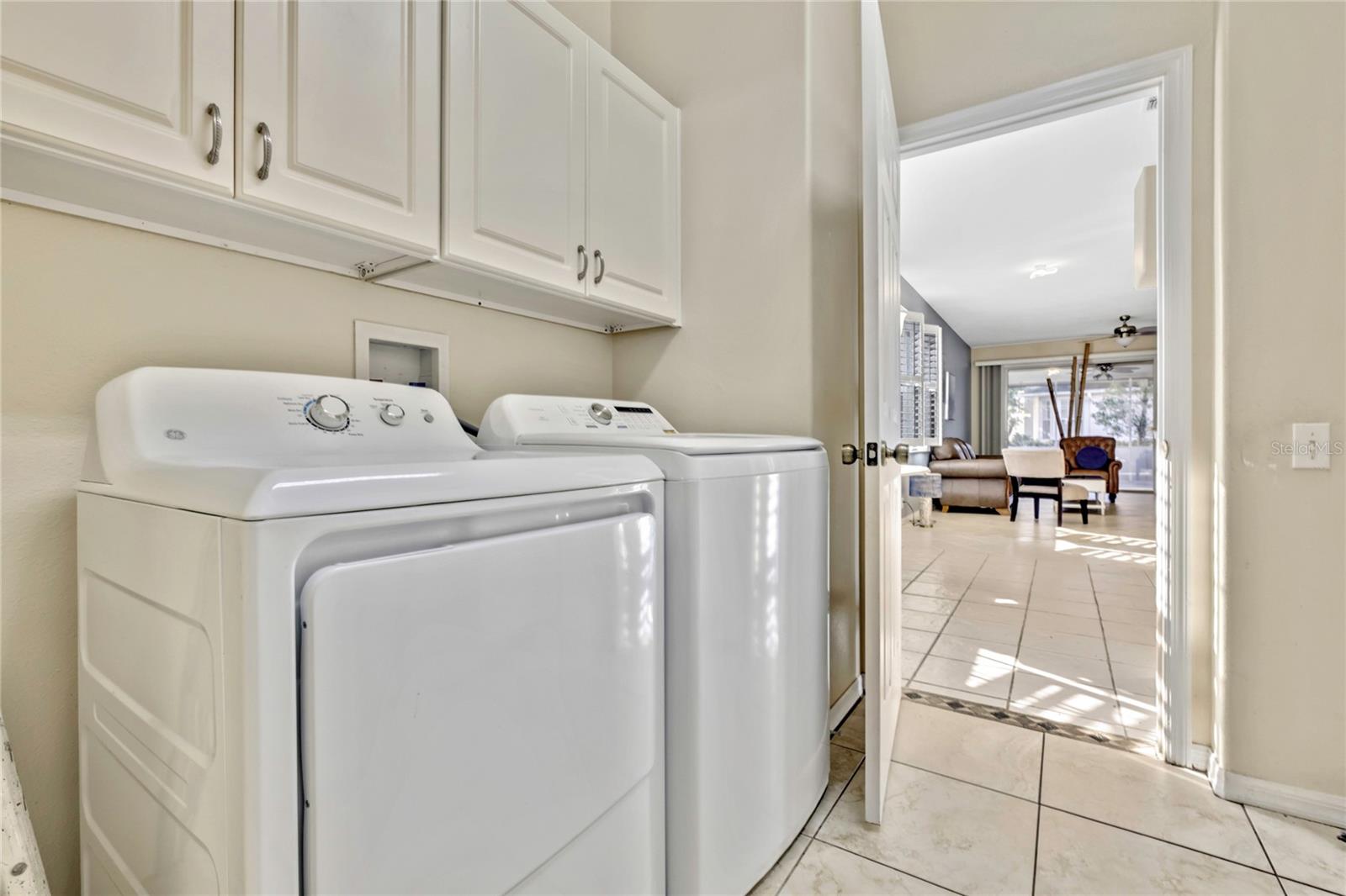 Washer and dryer stay with the home. Along with the laundry room closet, there is also plenty of cabinetry.