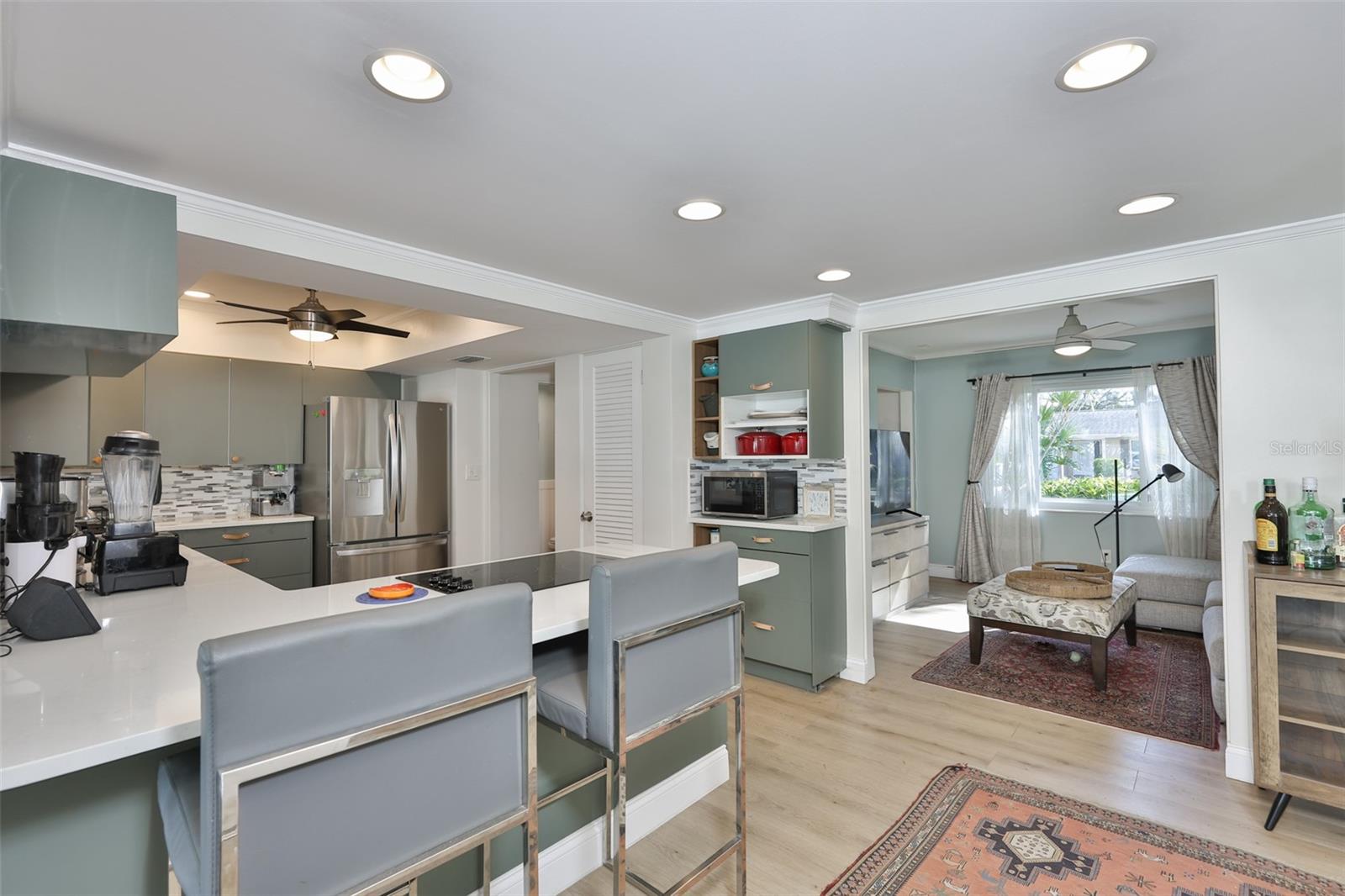 Breakfast bar with view of the kitchen and family room