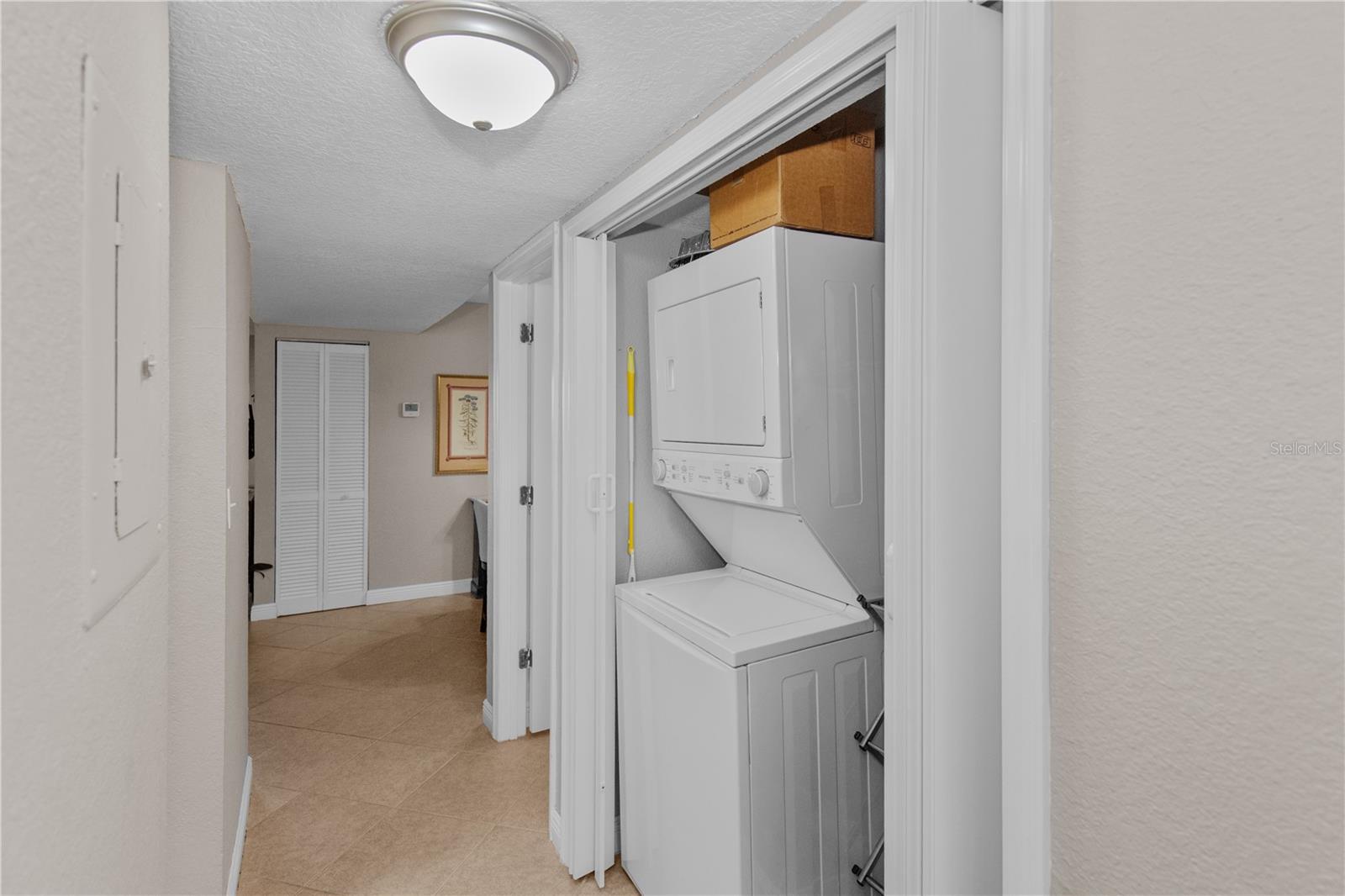 Washer/Dryer in closet hallway with extra storage