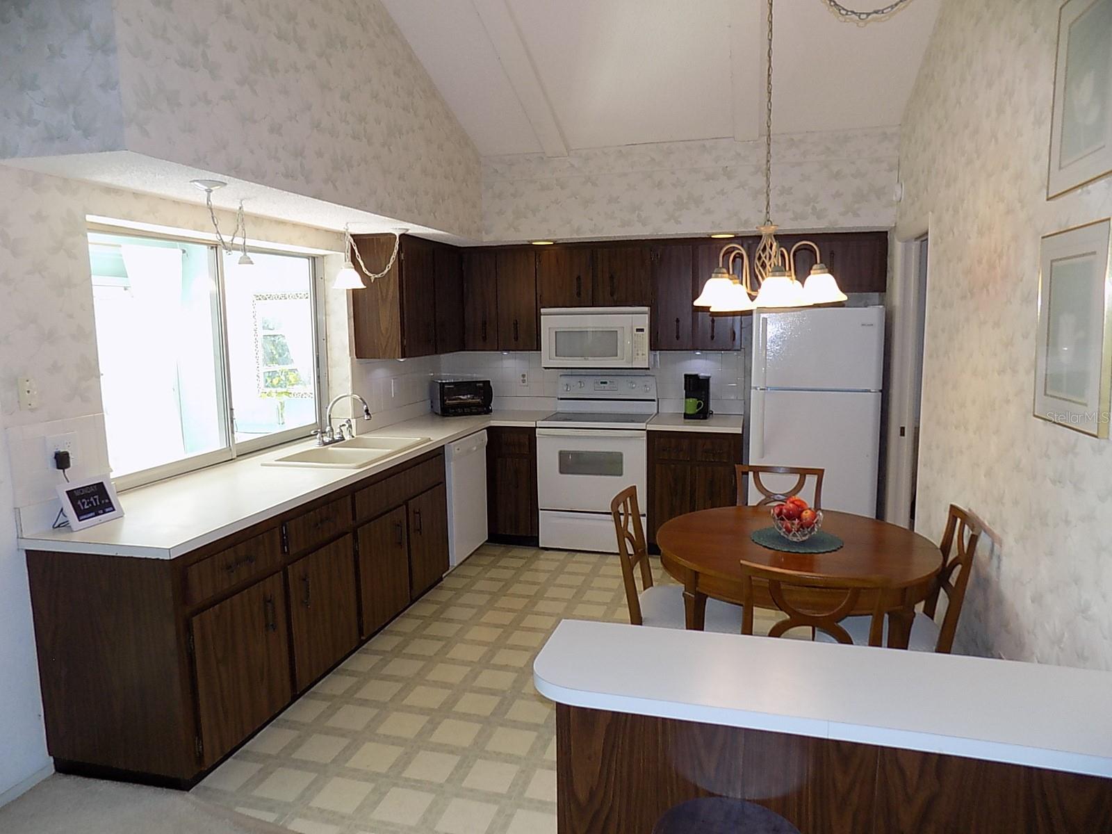 Eat-in Kitchen with white appliances & ample cabinet storage