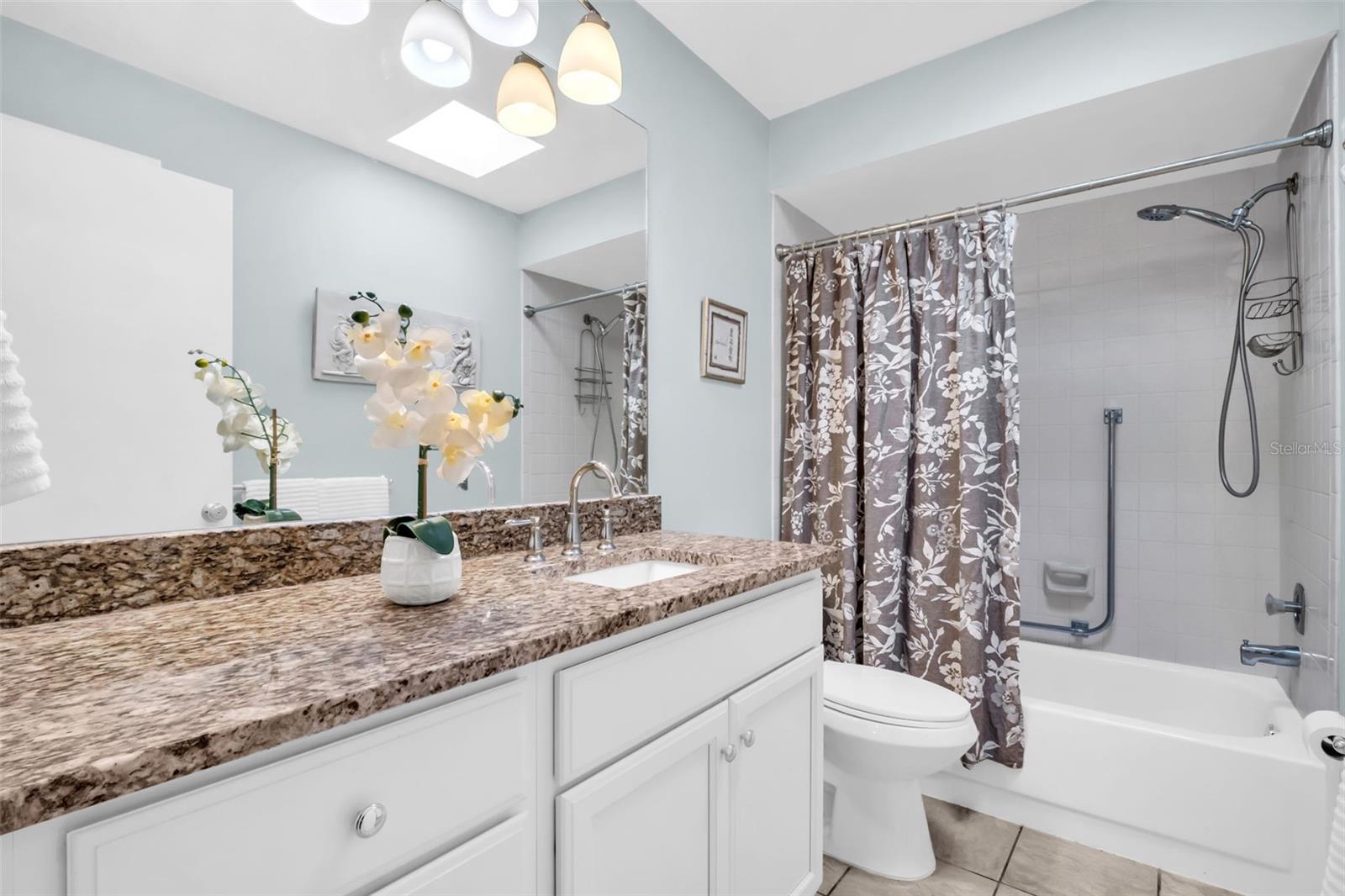 Updated hall bath perfectly located between main living and guest quarters offering an oversized vanity, granite countertops, & tub/shower combo~