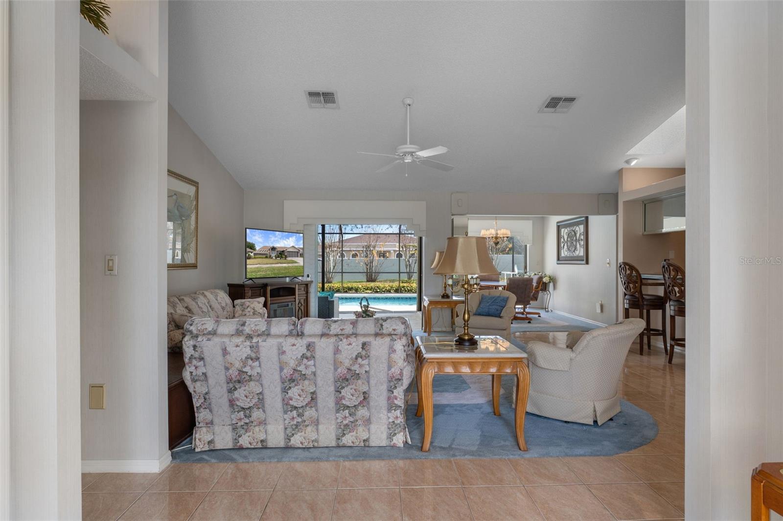 View from foyer into living room with sliders open to the patio.