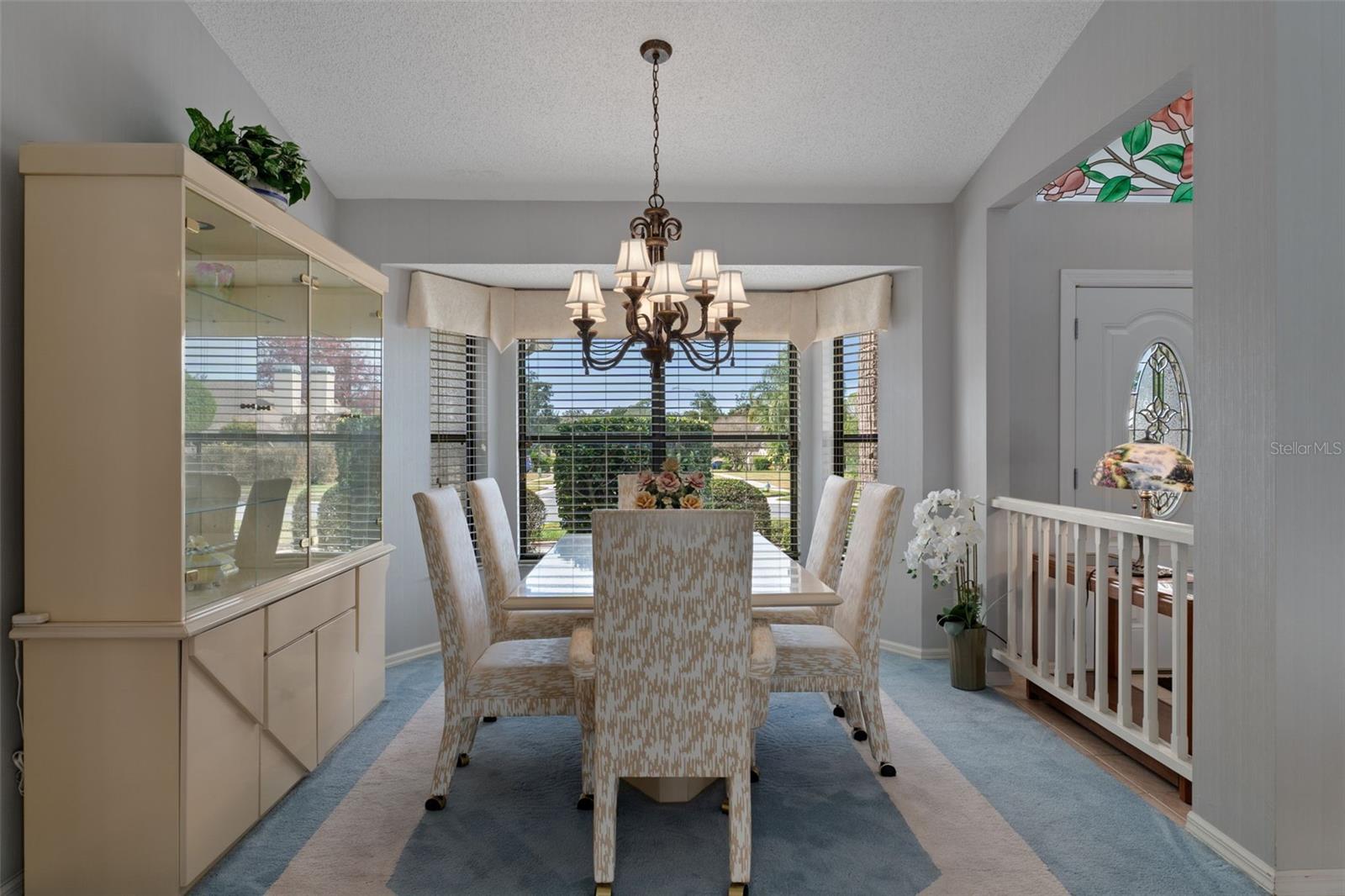 Formal dining room is situated up front and features a bay window and chandelier.