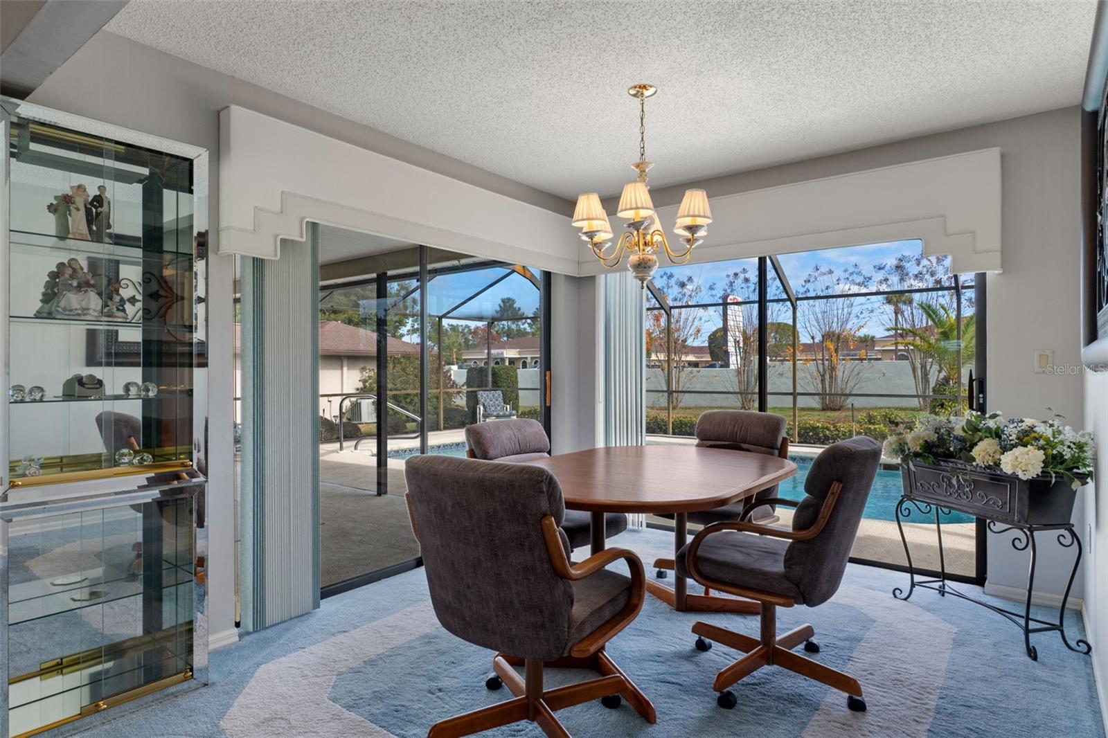 Sliding glass doors on 2 sides allow natural light and a great view to pool & patio.
