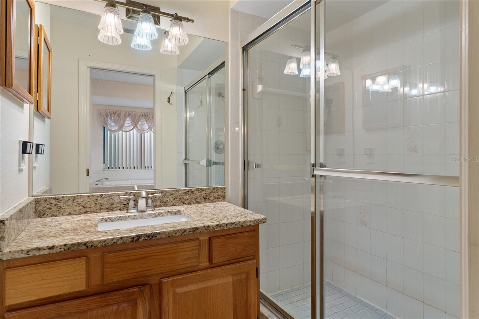 Upgraded vanity & walk-in shower with sliding doors.