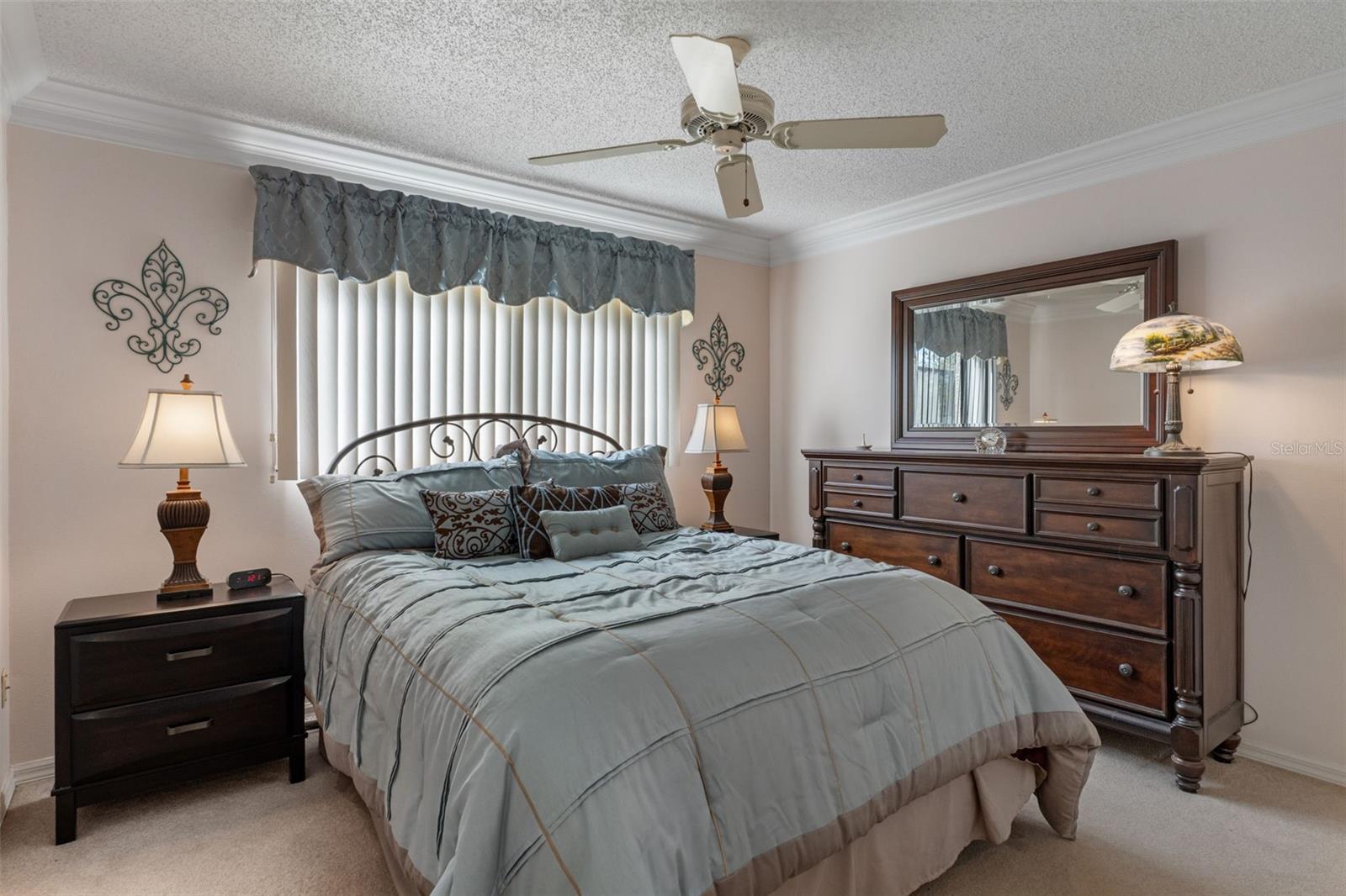 Bedroom 2 has crown molding detail, a ceiling fan and comes furnished.
