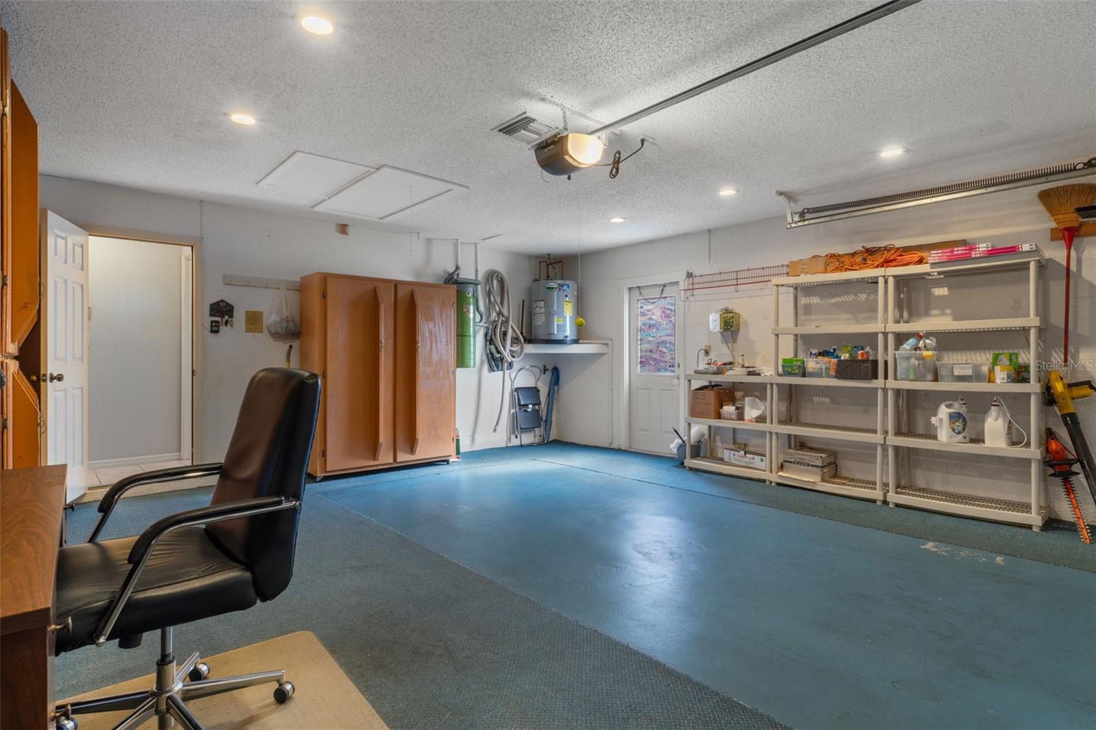 Numerous built in storage cabinets on 2 walls and shelving on the other.  A handy side door is great to use when working in the yard or bringing out the trash which is stored behind a fence panel just outside.