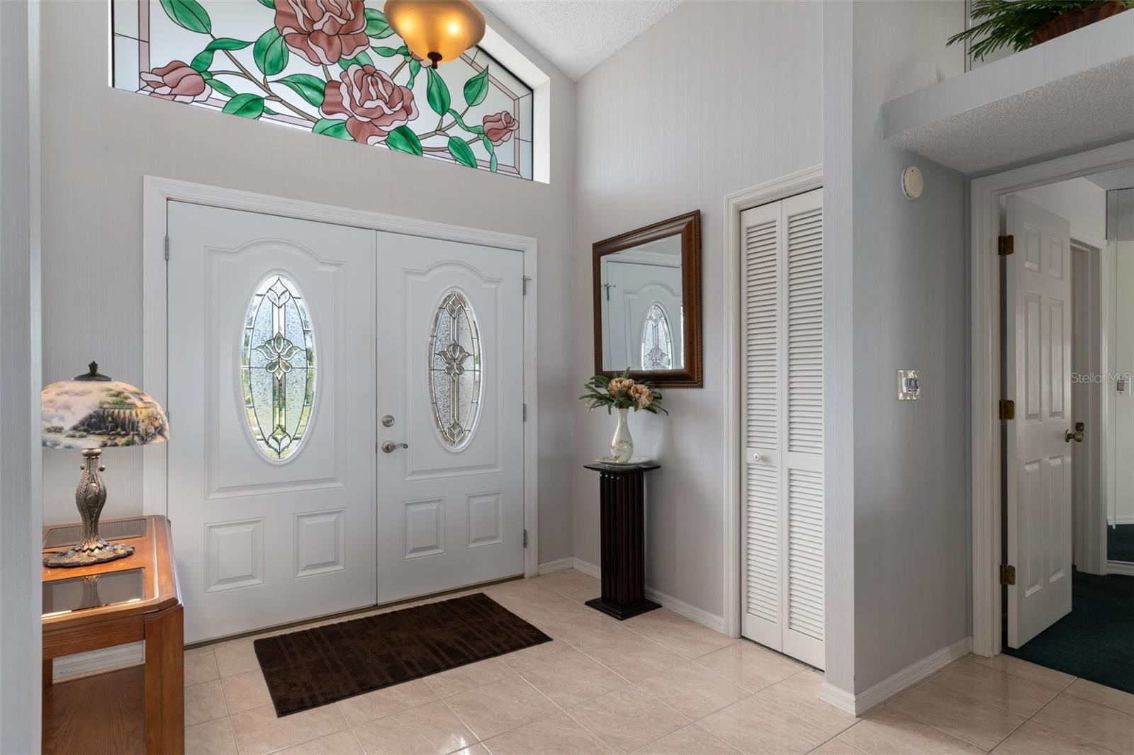 Beautiful glass detail in this ideal foyer which has a handy coat closet.