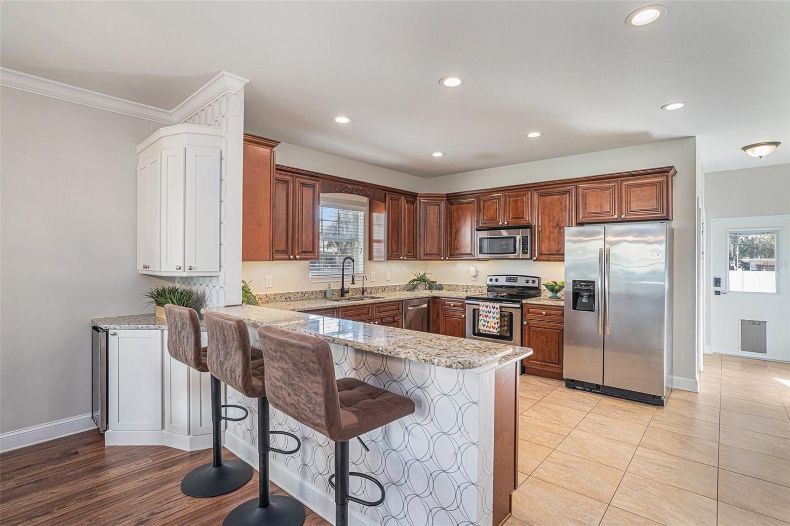 Wine refrigerator, counter height bar, view of kitchen