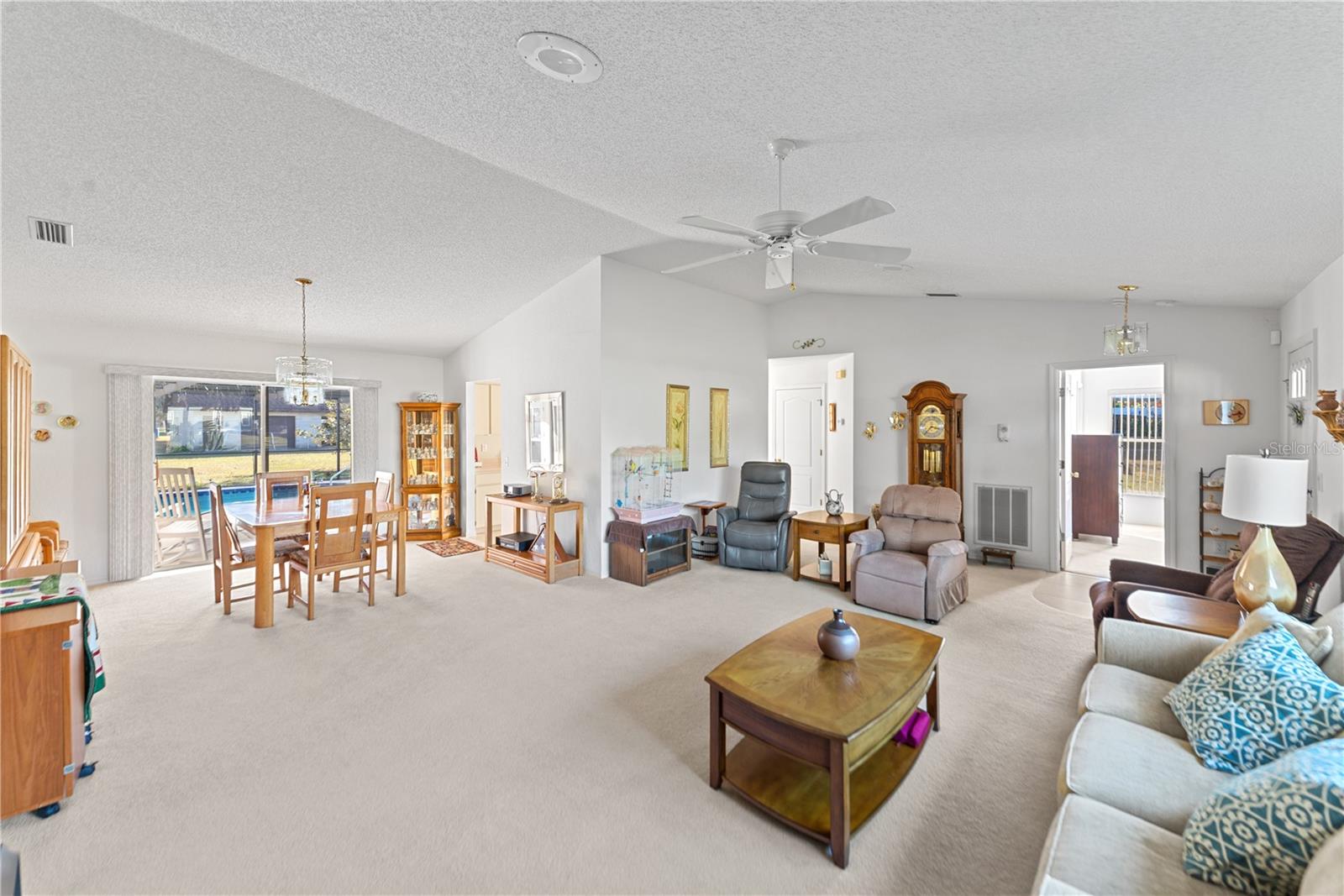 Living room opens to dining room and pool lanai - your own paradise